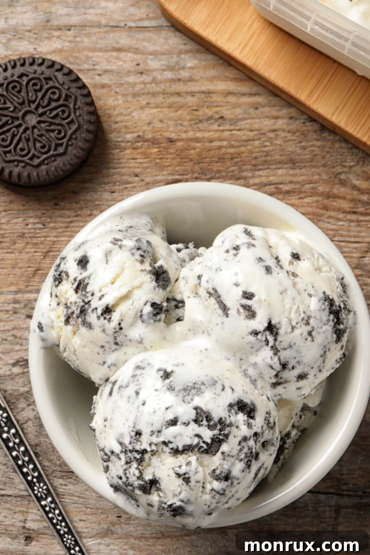 Close-up shot of the creamy, rich texture of cookies and cream nice cream, speckled with chocolate cookie pieces.