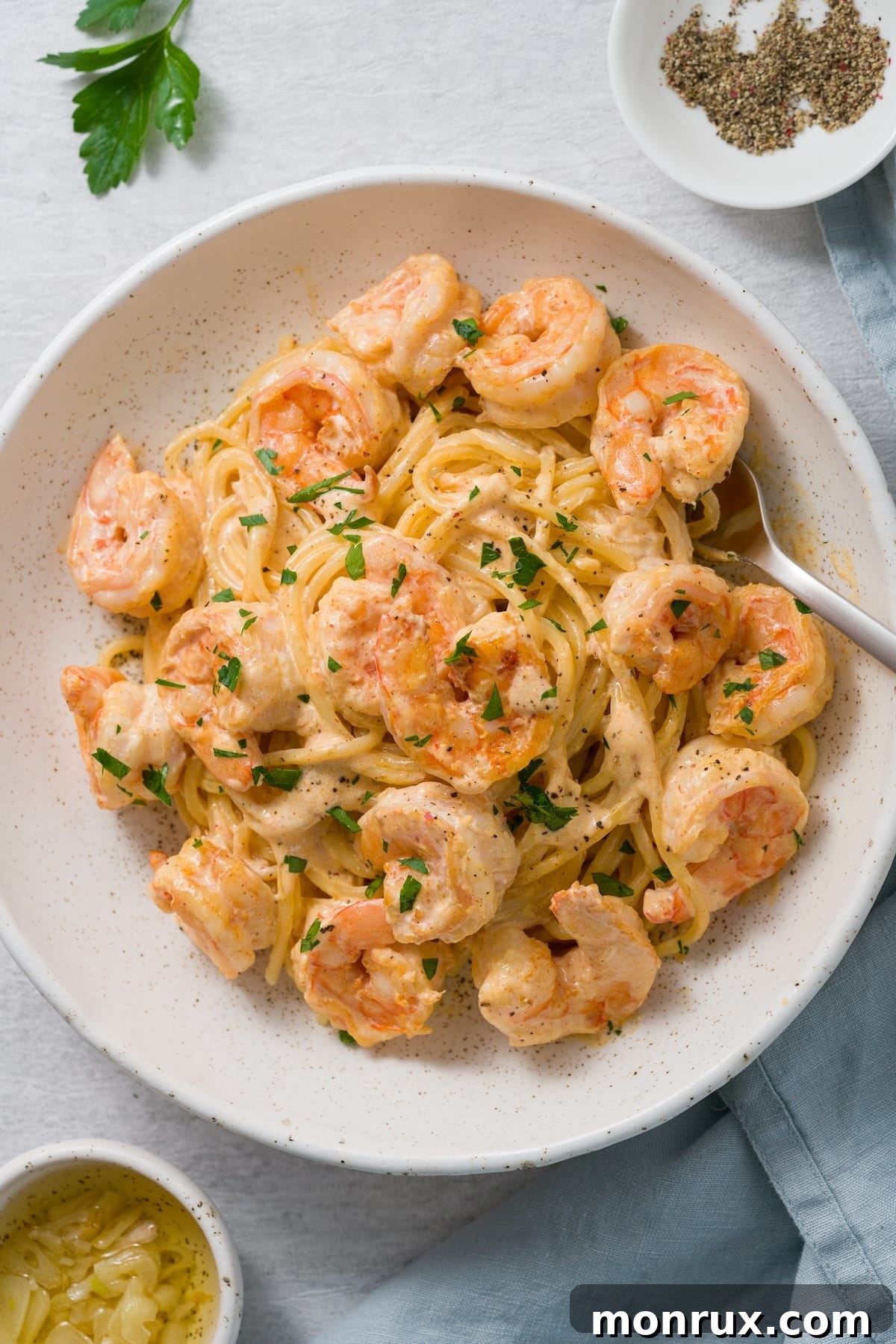 Vibrant creamy coconut shrimp dish, tossed with pasta and garnished with fresh herbs, showcasing a rich, dairy-free coconut sauce.