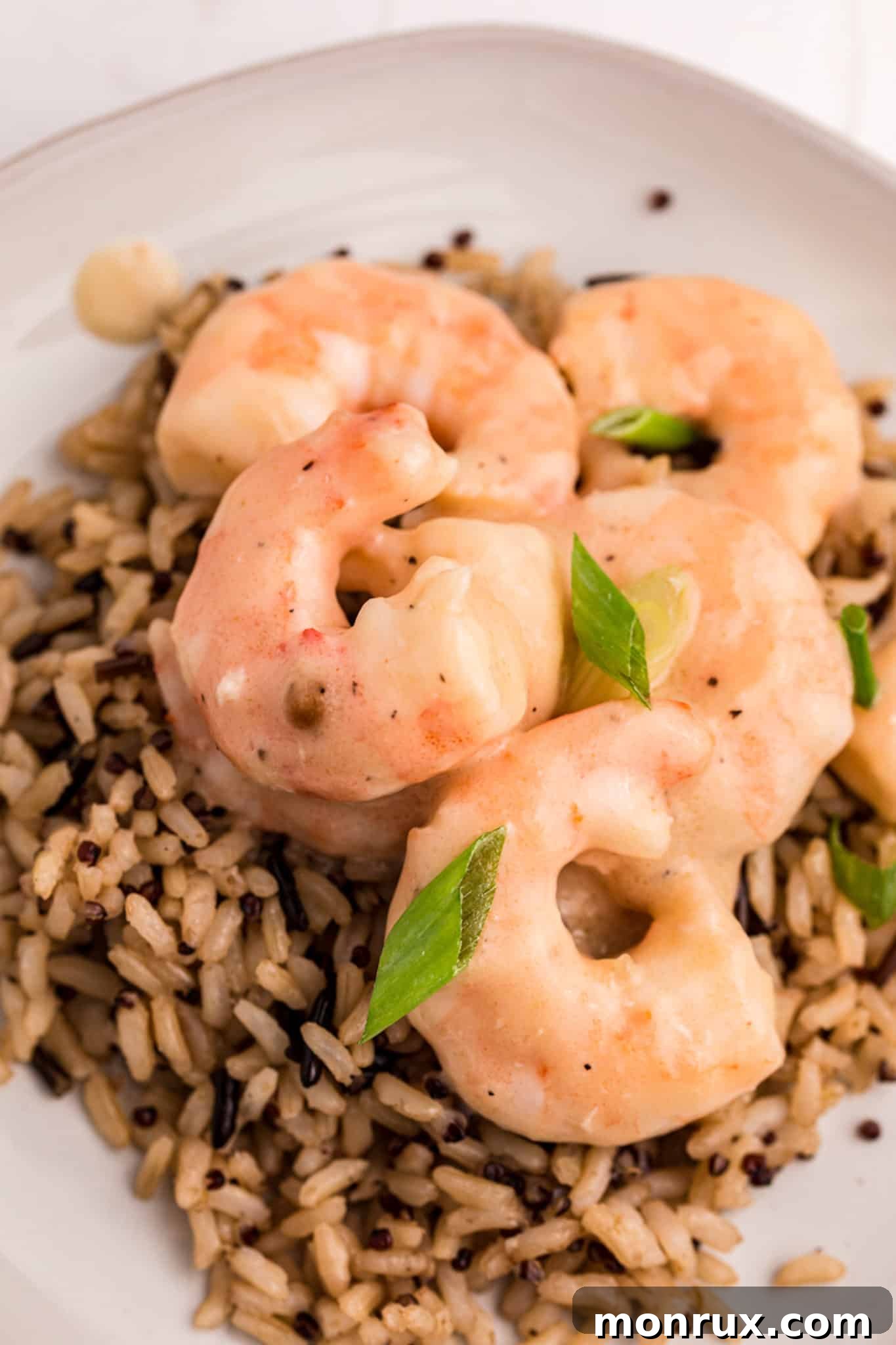 Close-up of creamy shrimp with vibrant green onions, emphasizing the rich texture of the dairy-free sauce.