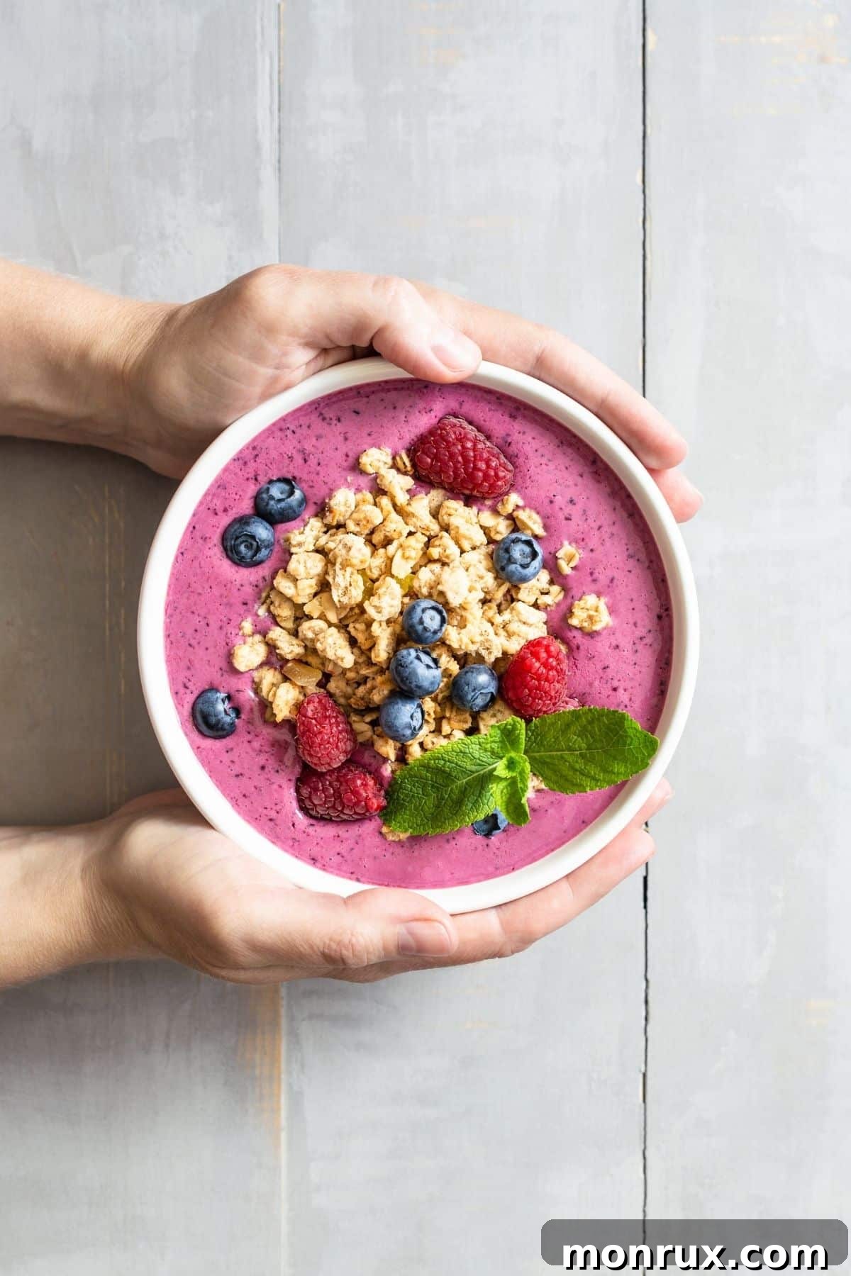 healthy fruit smoothie bowl topped with granola.