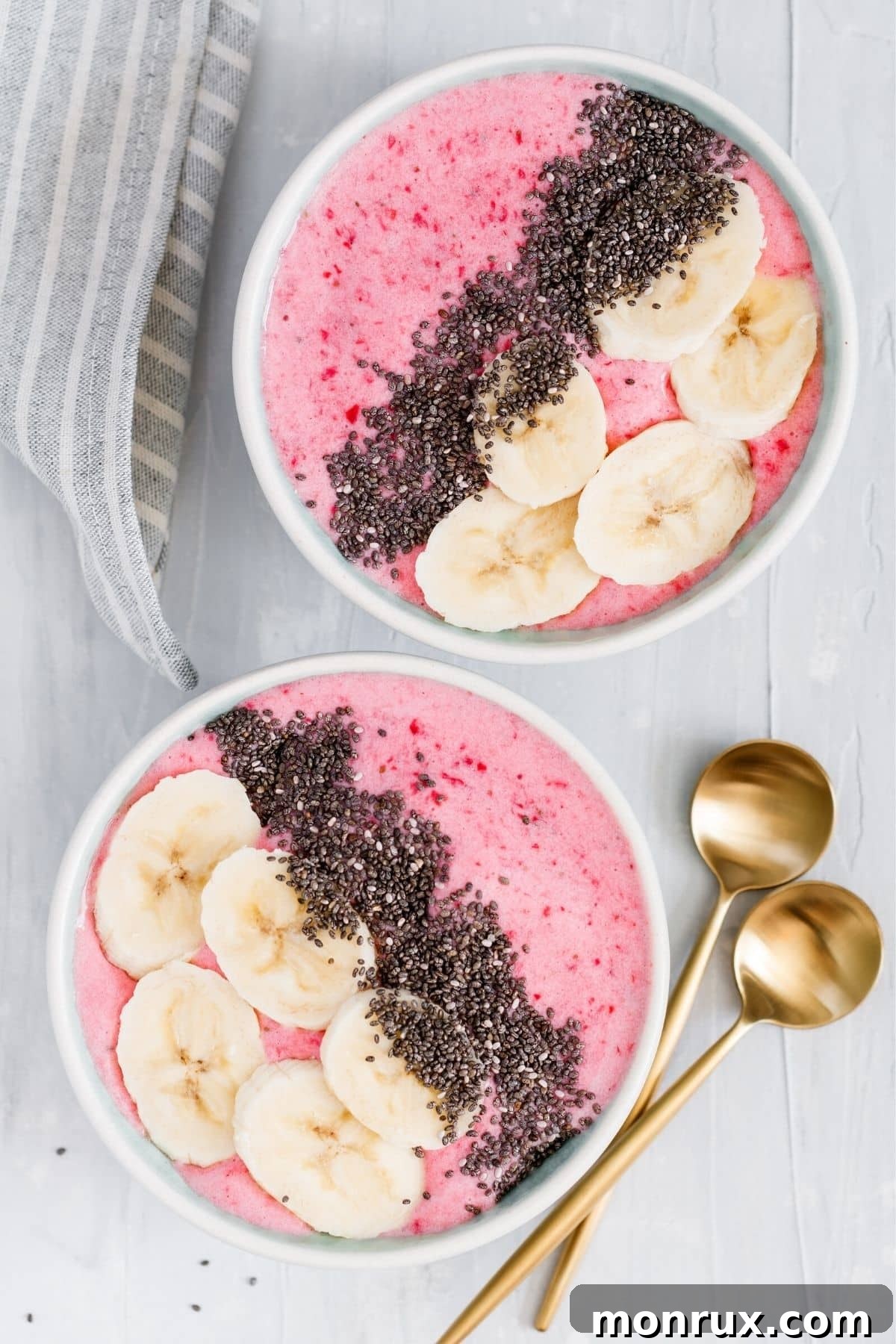 beautiful pink smoothie bowls with bananas and chia seeds.