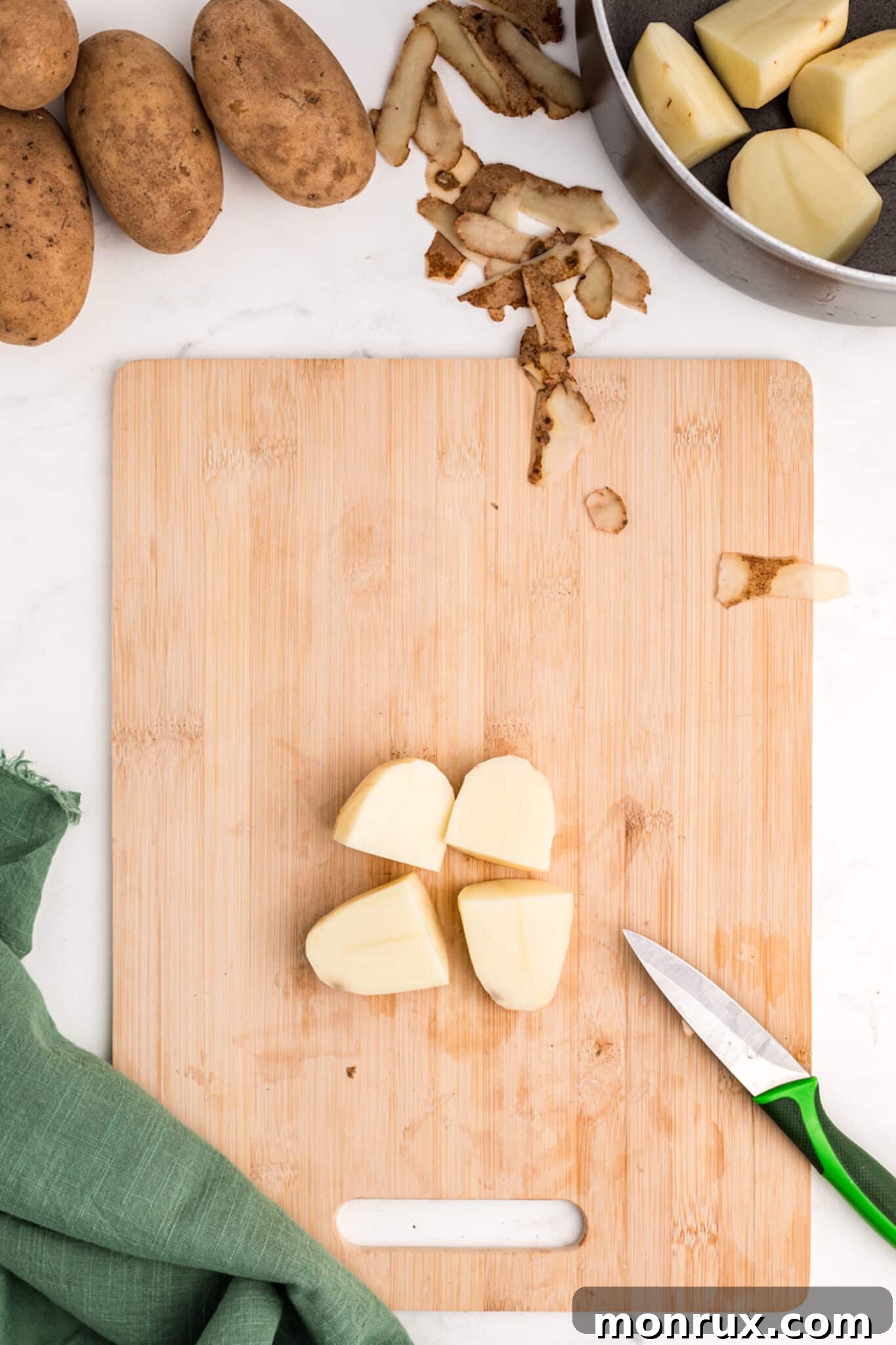 Peeled and uniformly cut potatoes, ready for cooking.
