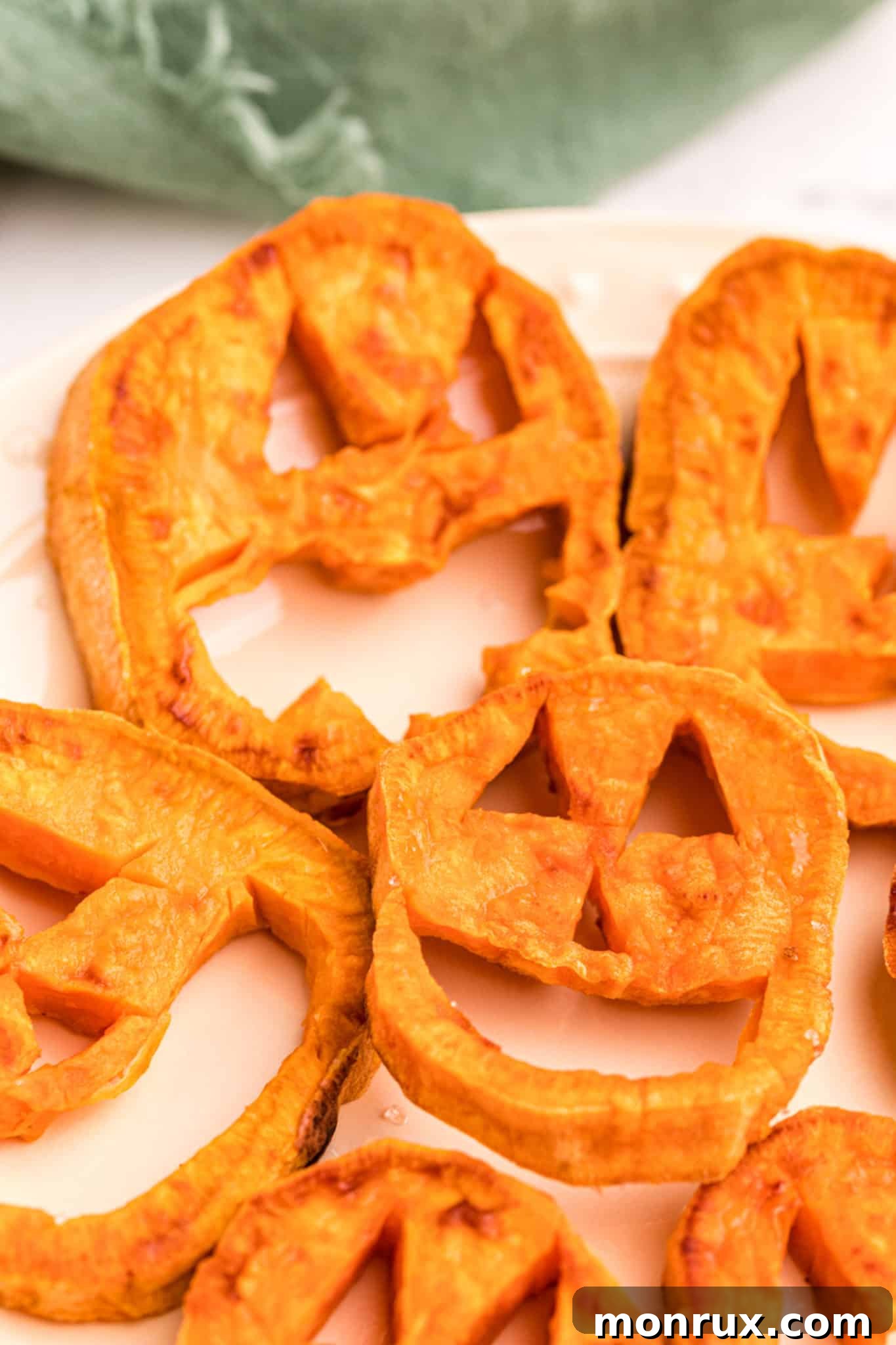 A close-up shot of a perfectly roasted sweet potato Jack O'-Lantern, golden brown and ready to be enjoyed.