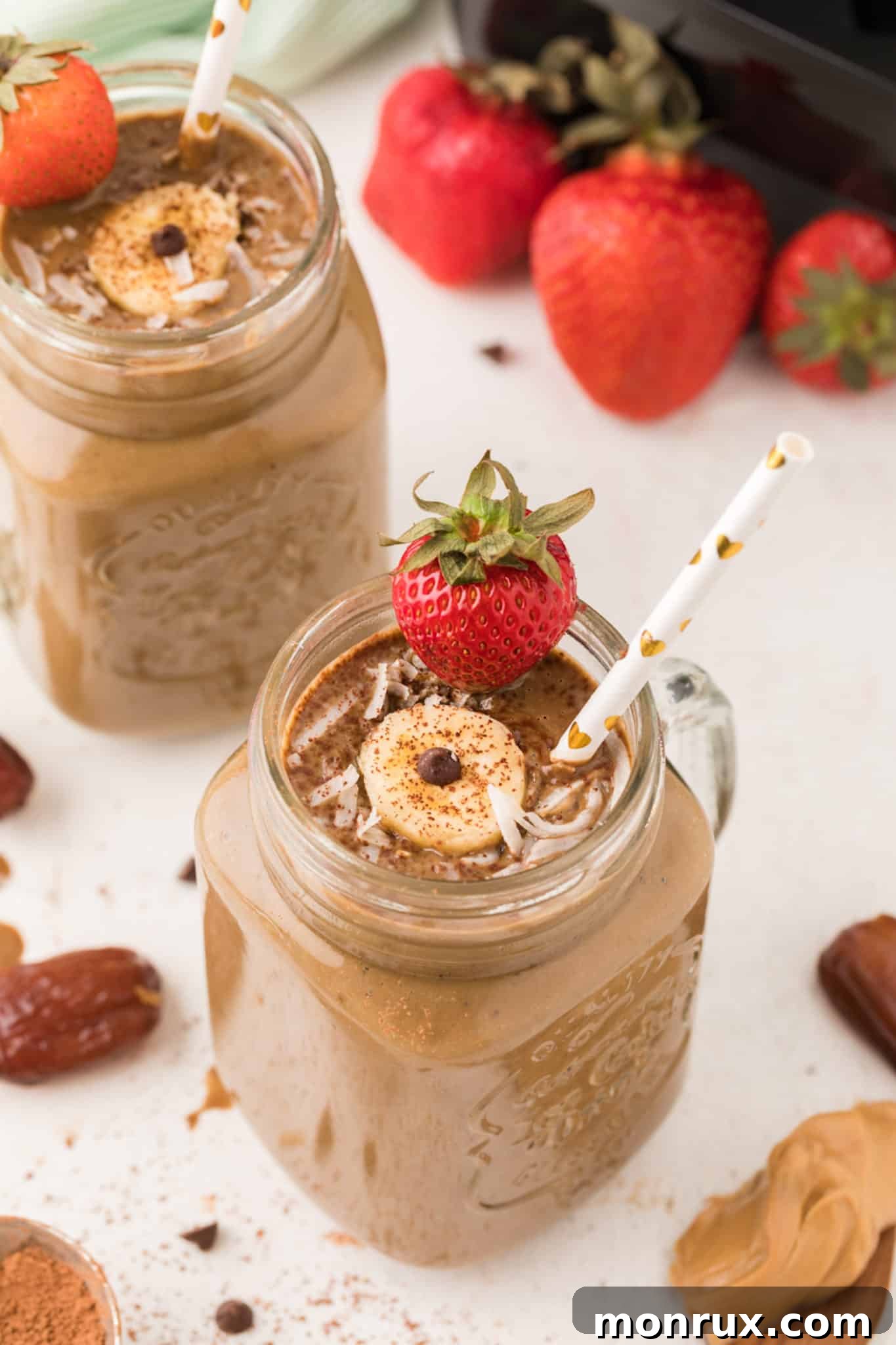 Delicious chocolate weight gain smoothie with strawberries and banana, served in a jar, ready for consumption.