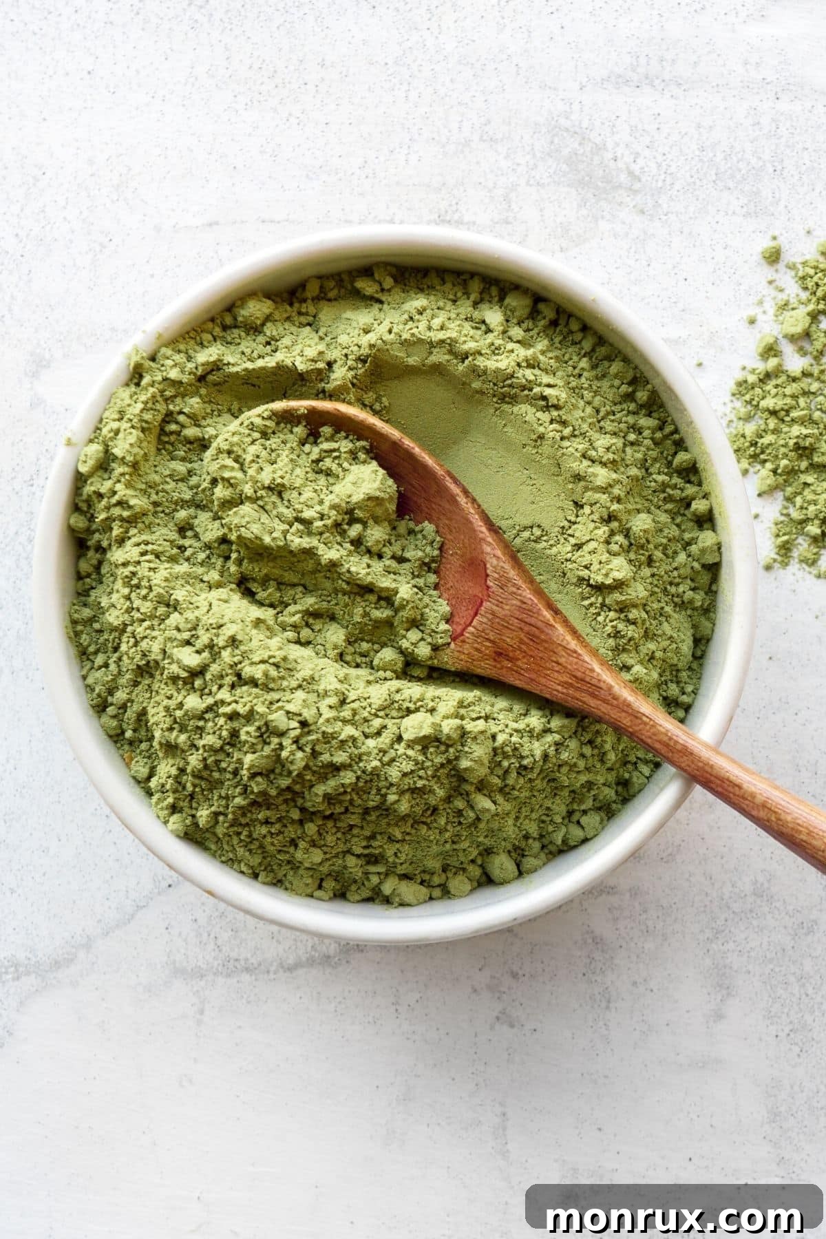 green broccoli sprout powder in a bowl.
