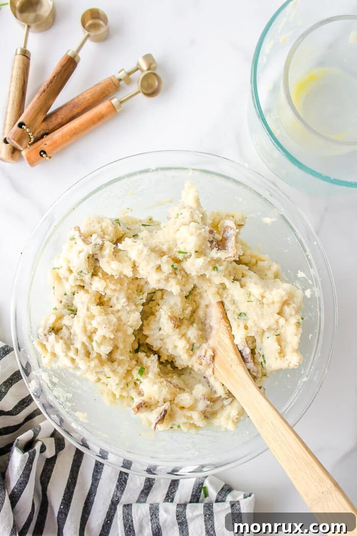 Mashed potato fritter mixture in a bowl, thoroughly stirred and ready for forming.