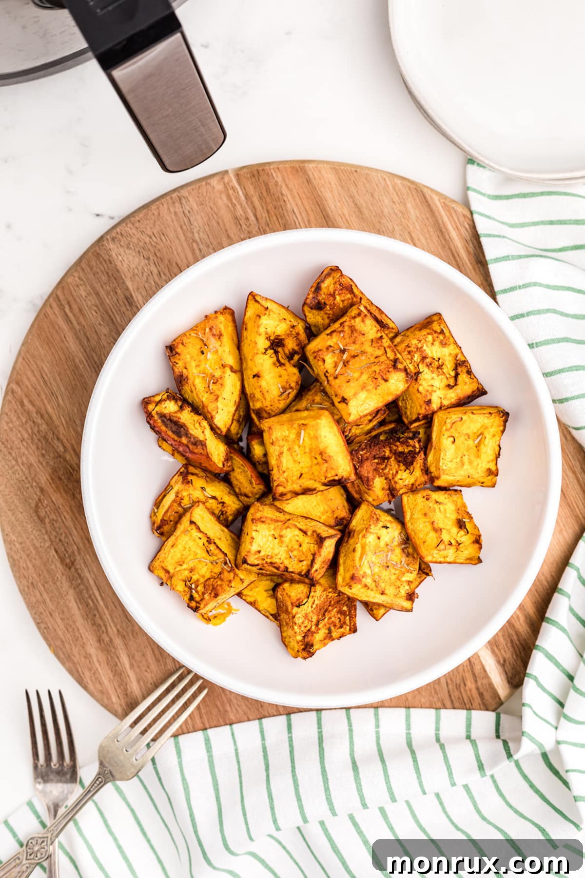roasted pumpkin chunks served in a white bowl.