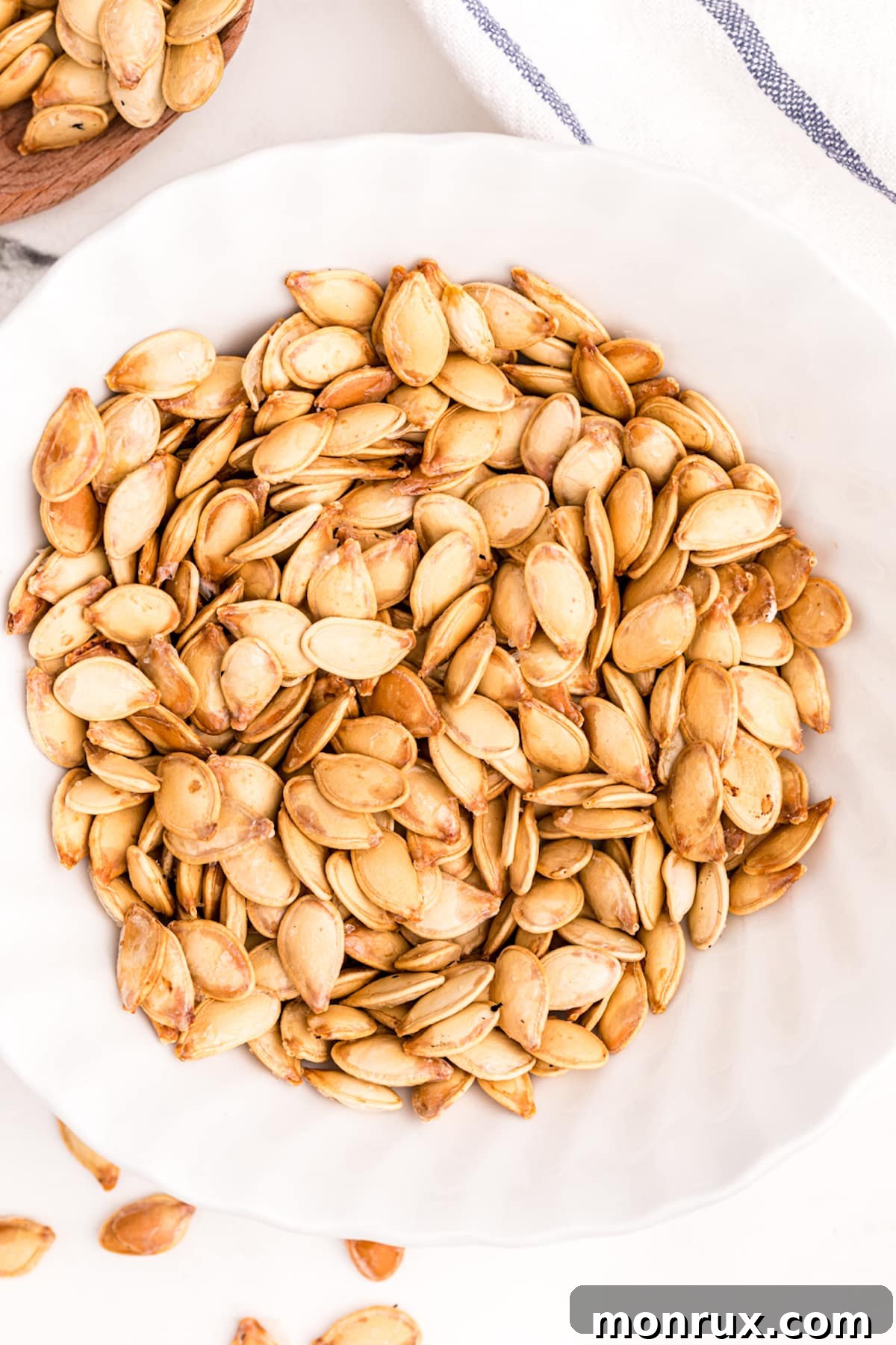roasted air fryer pumpkin seeds served in a white bowl.