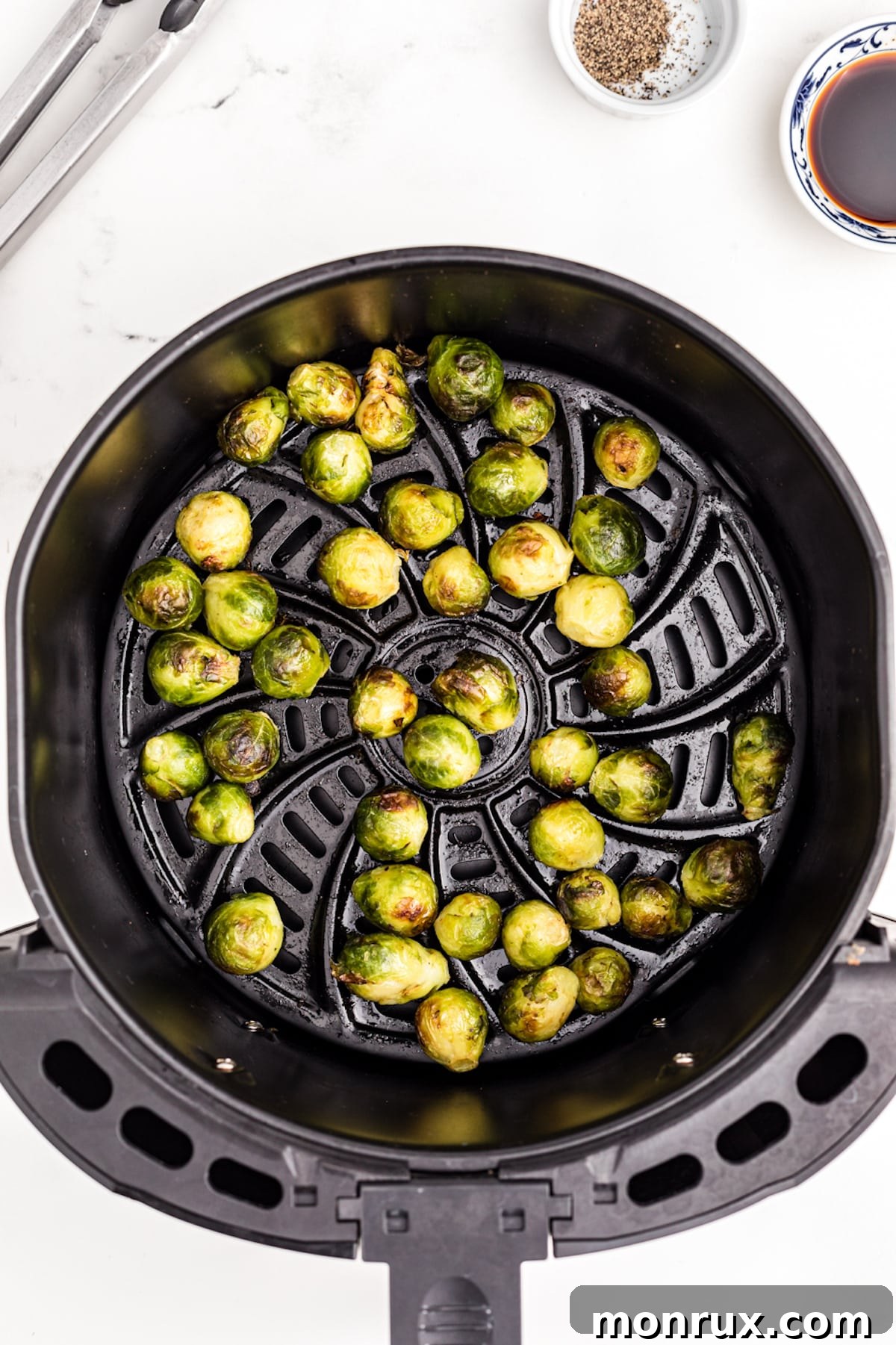 Crispy air fried frozen brussels sprouts in an air fryer basket, ready to serve.