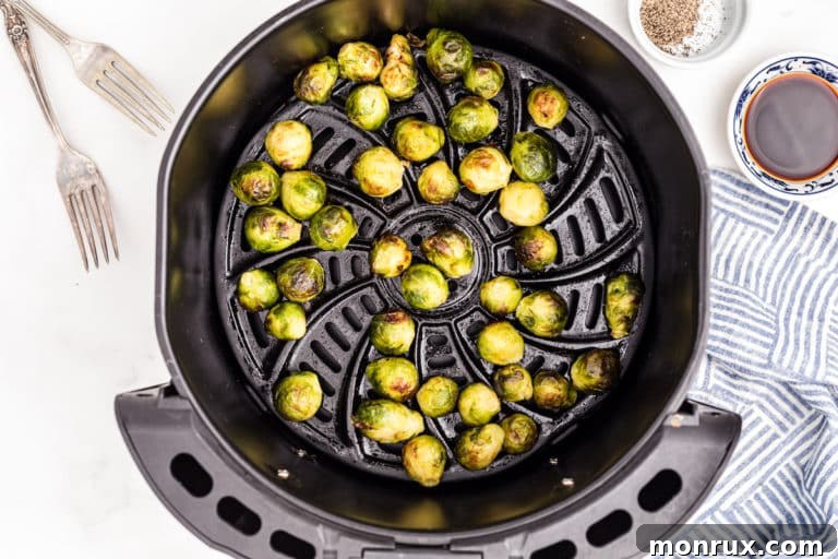 Crispy air fried brussels sprouts in a serving bowl, garnished.
