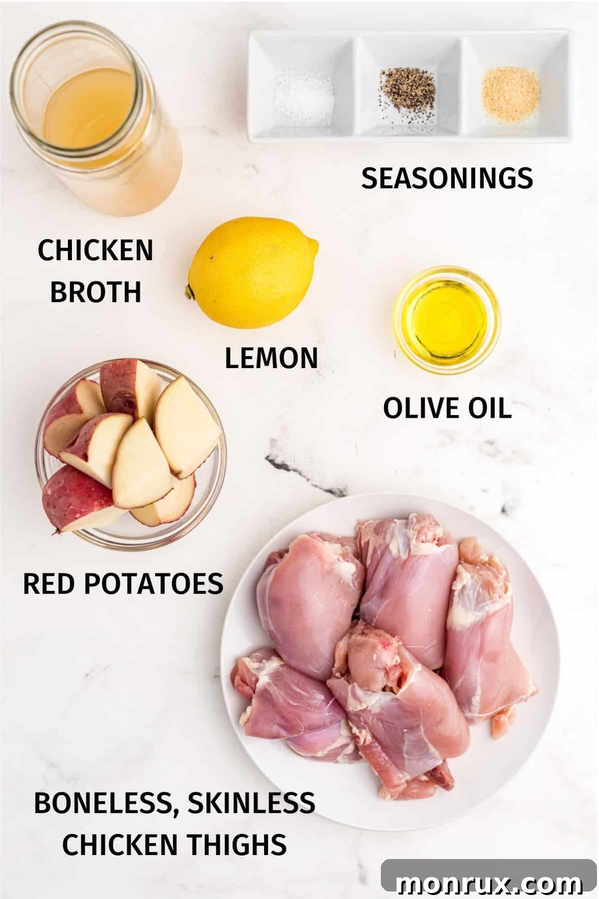 Various fresh ingredients laid out, including boneless skinless chicken thighs, red potatoes, lemon, and spices, for an Instant Pot recipe.