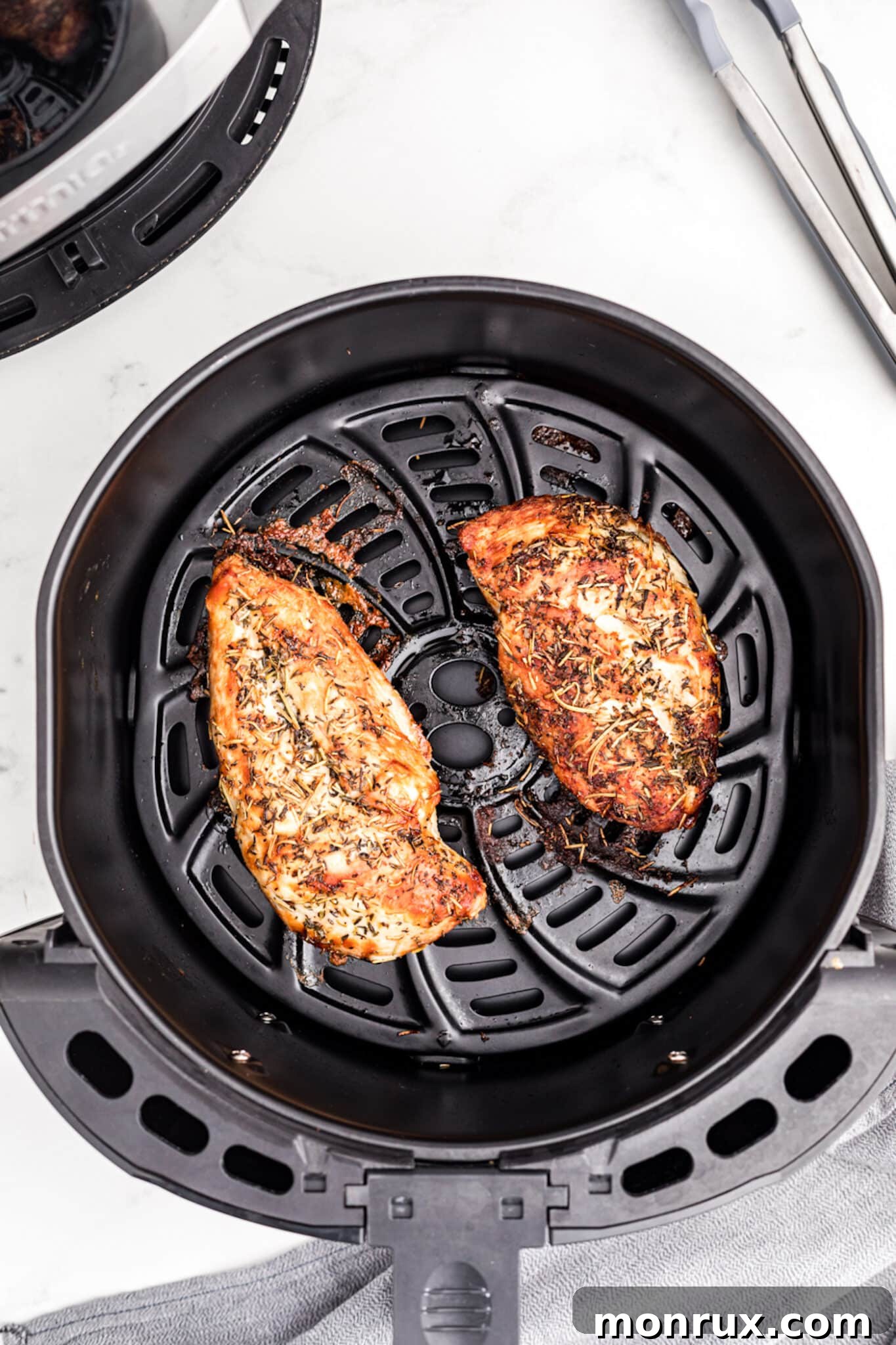 cooked turkey tenderloins inside air fryer.