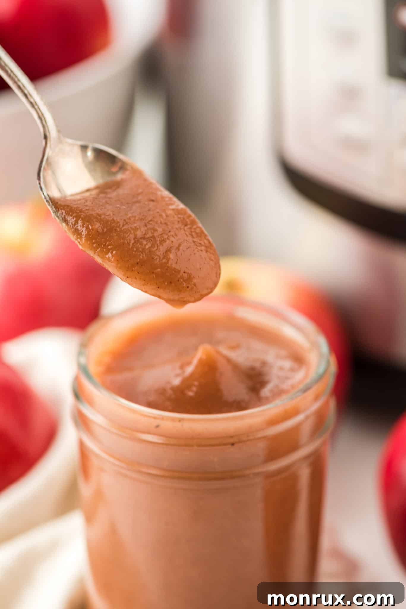 A spoonful of instant pot apple butter, showing its smooth and rich texture.
