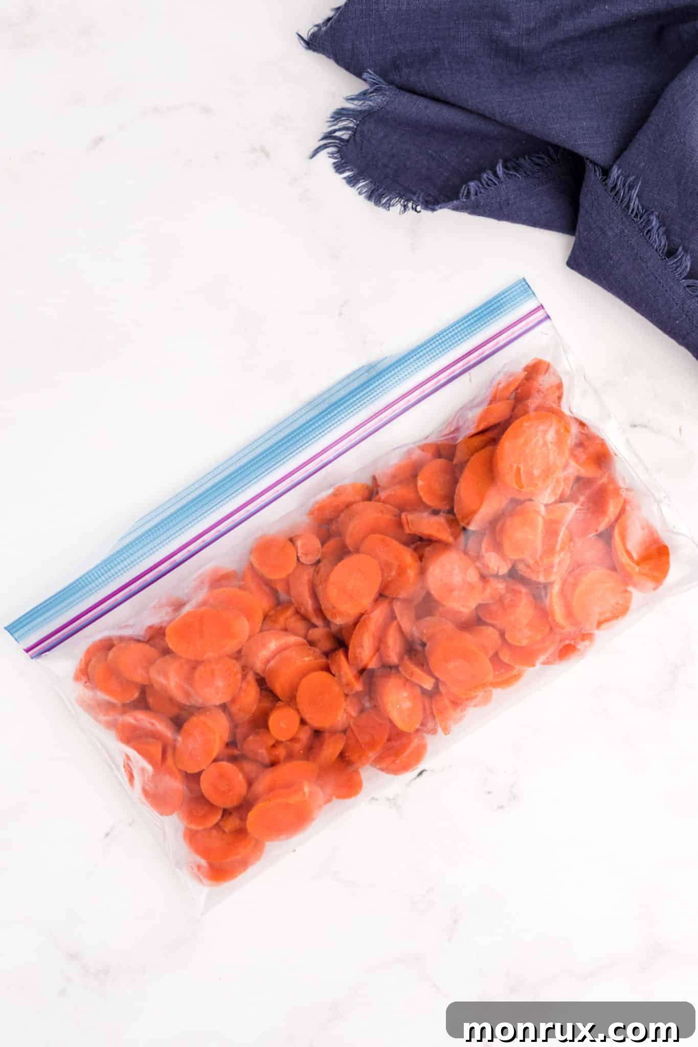 A bag of frozen carrots, clearly labeled and ready for the freezer.