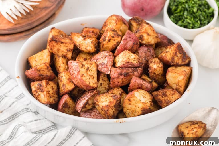 A bowl of roasted Mexican potatoes, garnished with fresh cilantro, ready to be served as a side dish.
