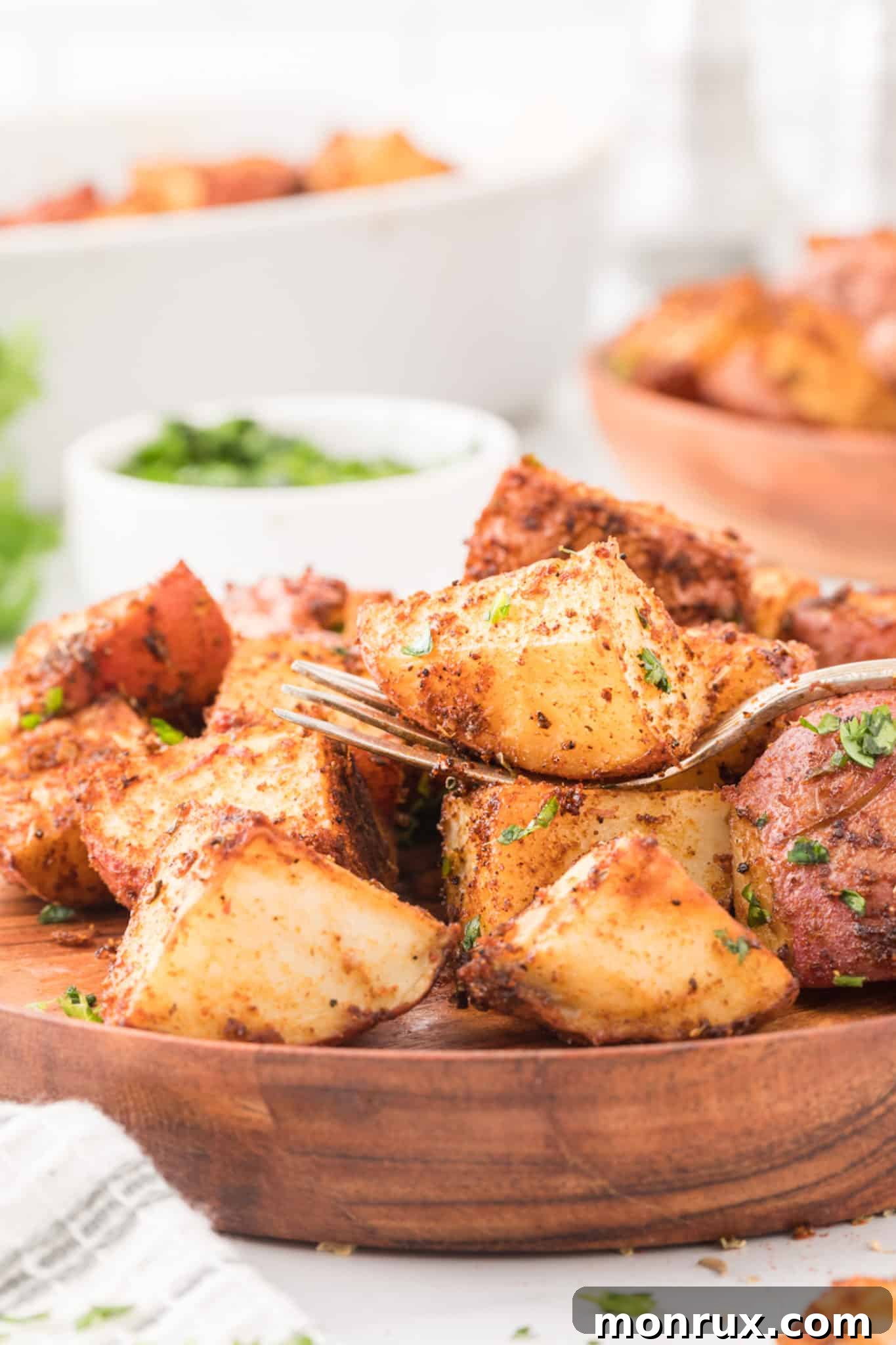 A forkful of perfectly roasted Mexican potatoes, showcasing their crispy exterior and tender interior.