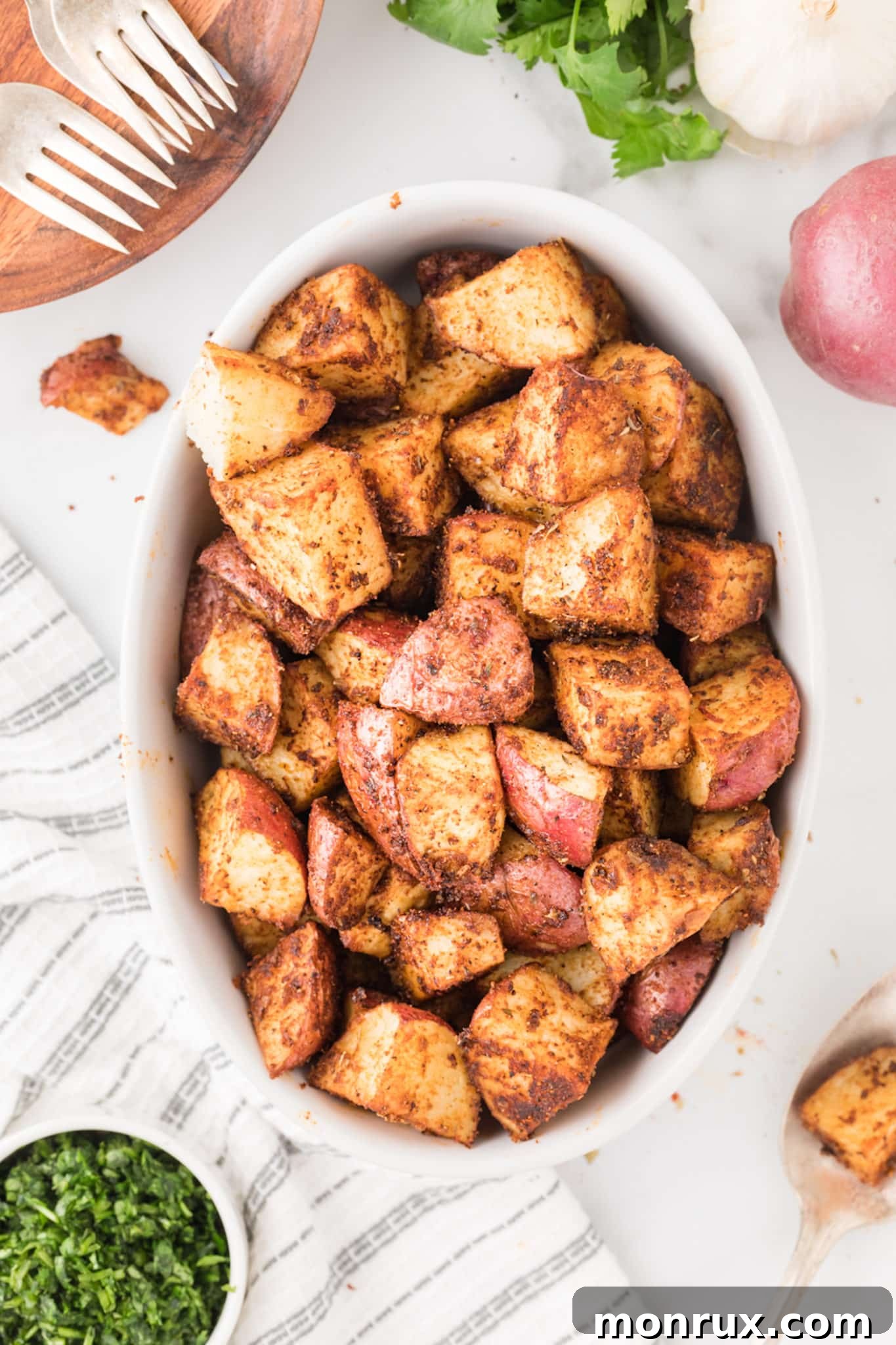 A bowl of roasted Mexican potatoes generously seasoned with vibrant spices, ready for serving.