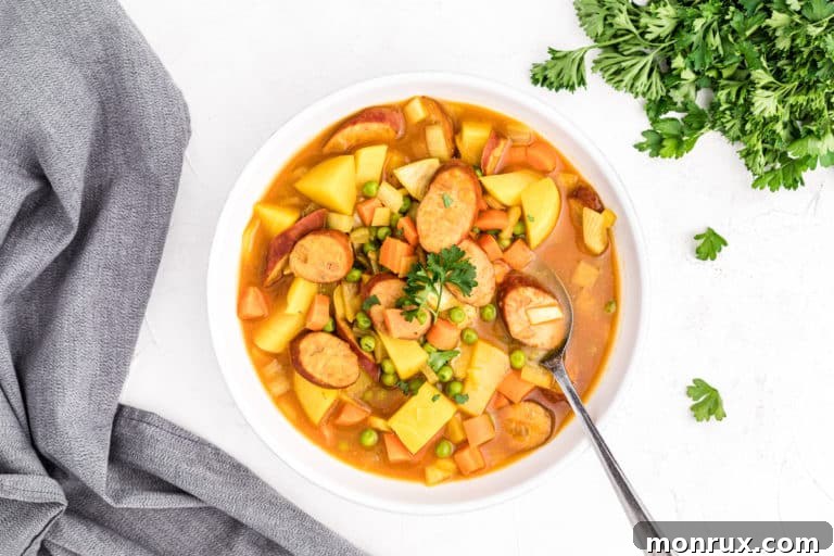 A delicious bowl of curry sausage soup, ready to be served and enjoyed.