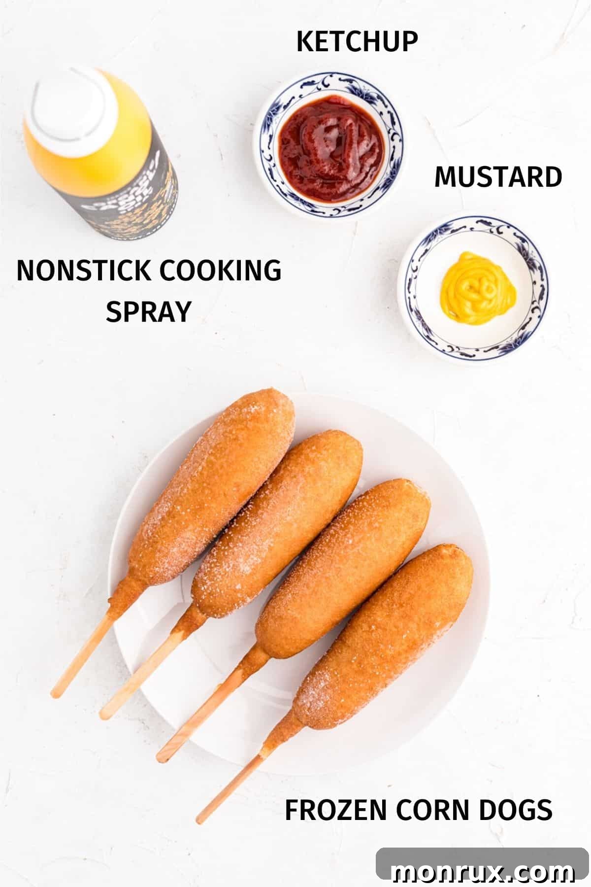 Ingredients for making air fryer corn dogs, including frozen corn dogs and nonstick spray.