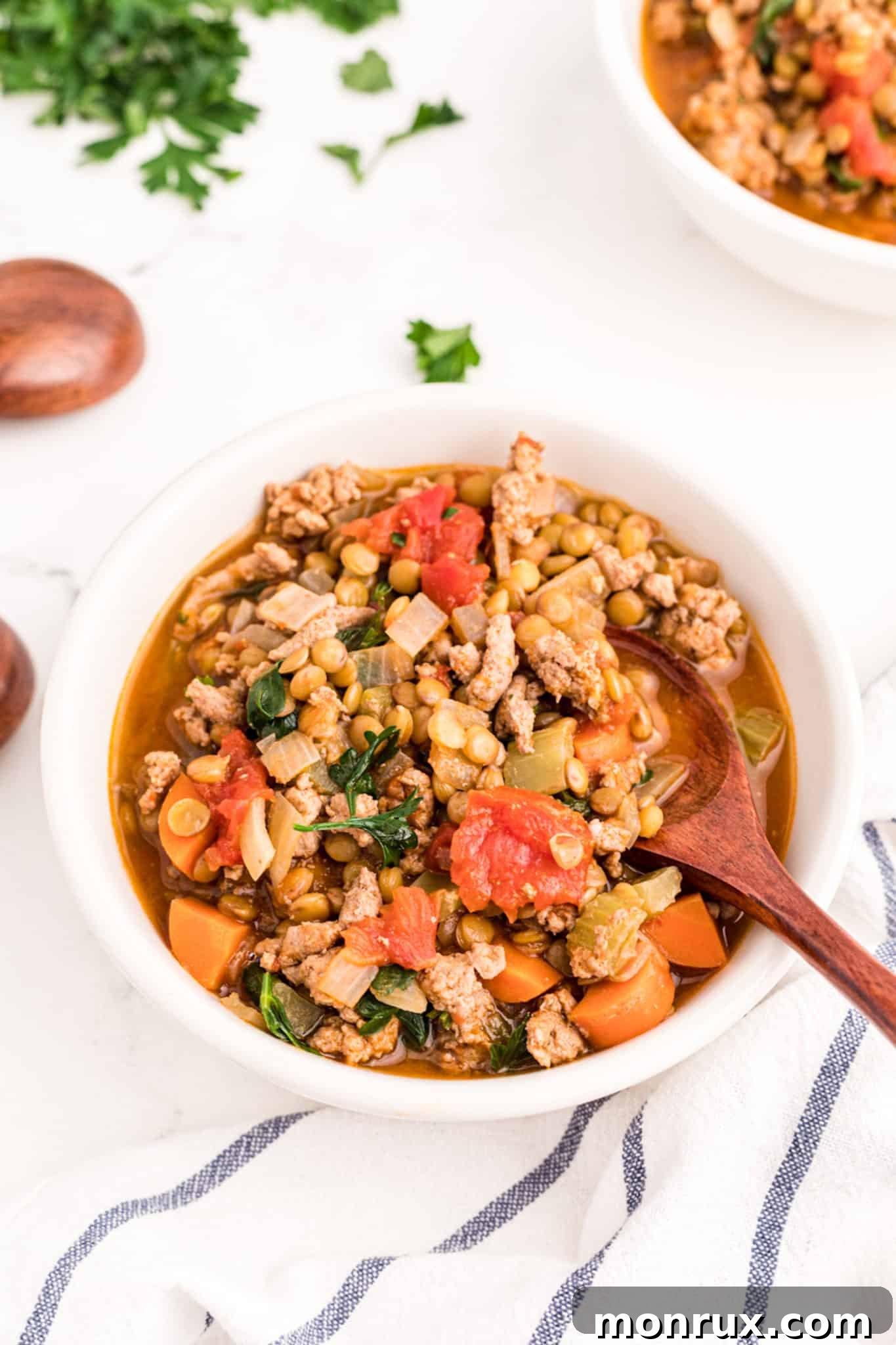 A comforting bowl of Ground Turkey Lentil Soup, rich in color and texture, garnished with fresh herbs.