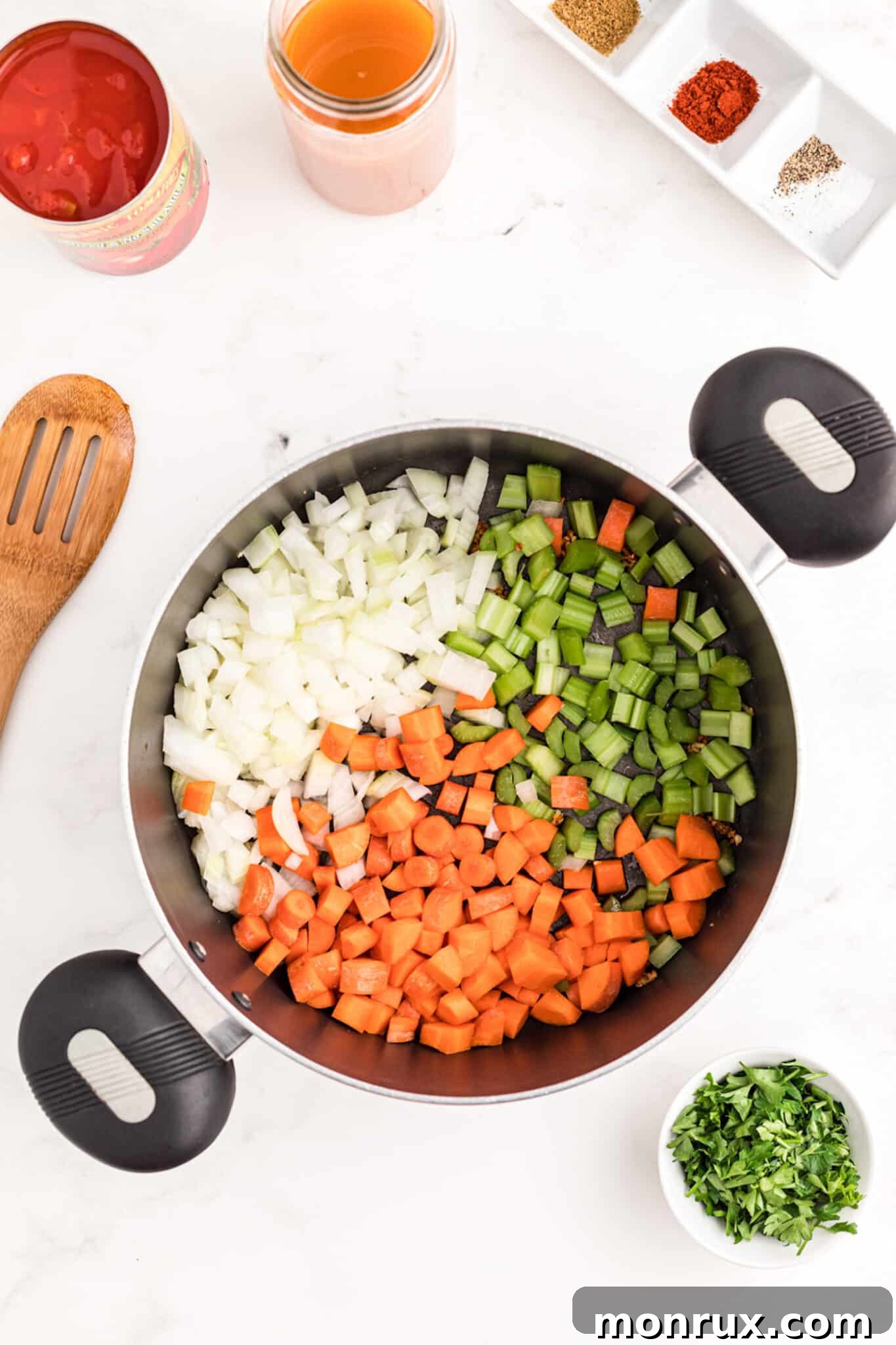 Freshly chopped vegetables sautéing in a pot to build the flavor base for turkey lentil soup.