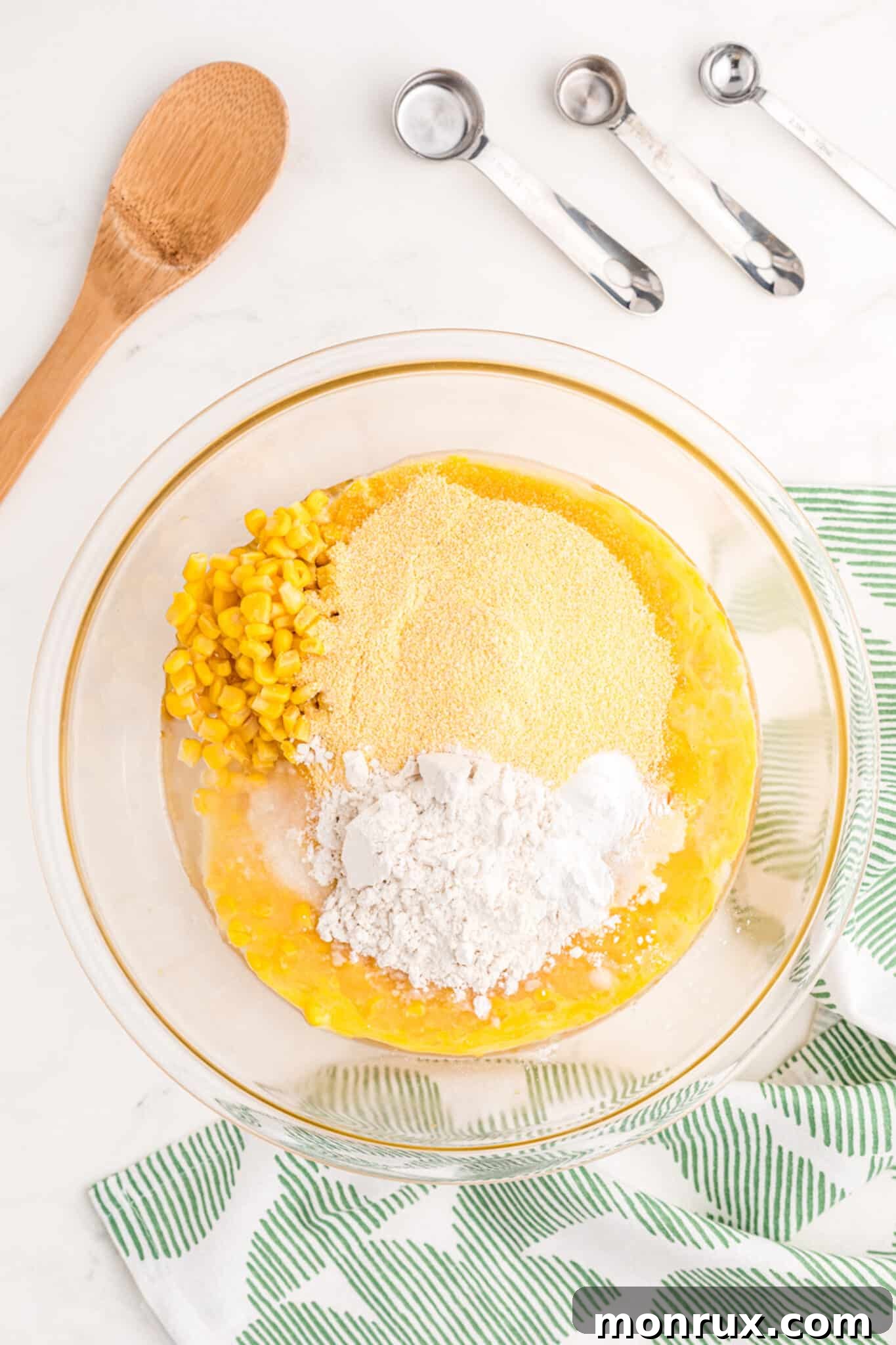 All dry and wet ingredients for corn casserole combined in a large mixing bowl.