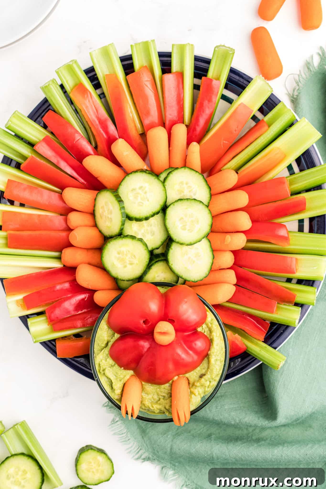 A beautifully arranged vegetable platter in the shape of a turkey, perfect for Thanksgiving.
