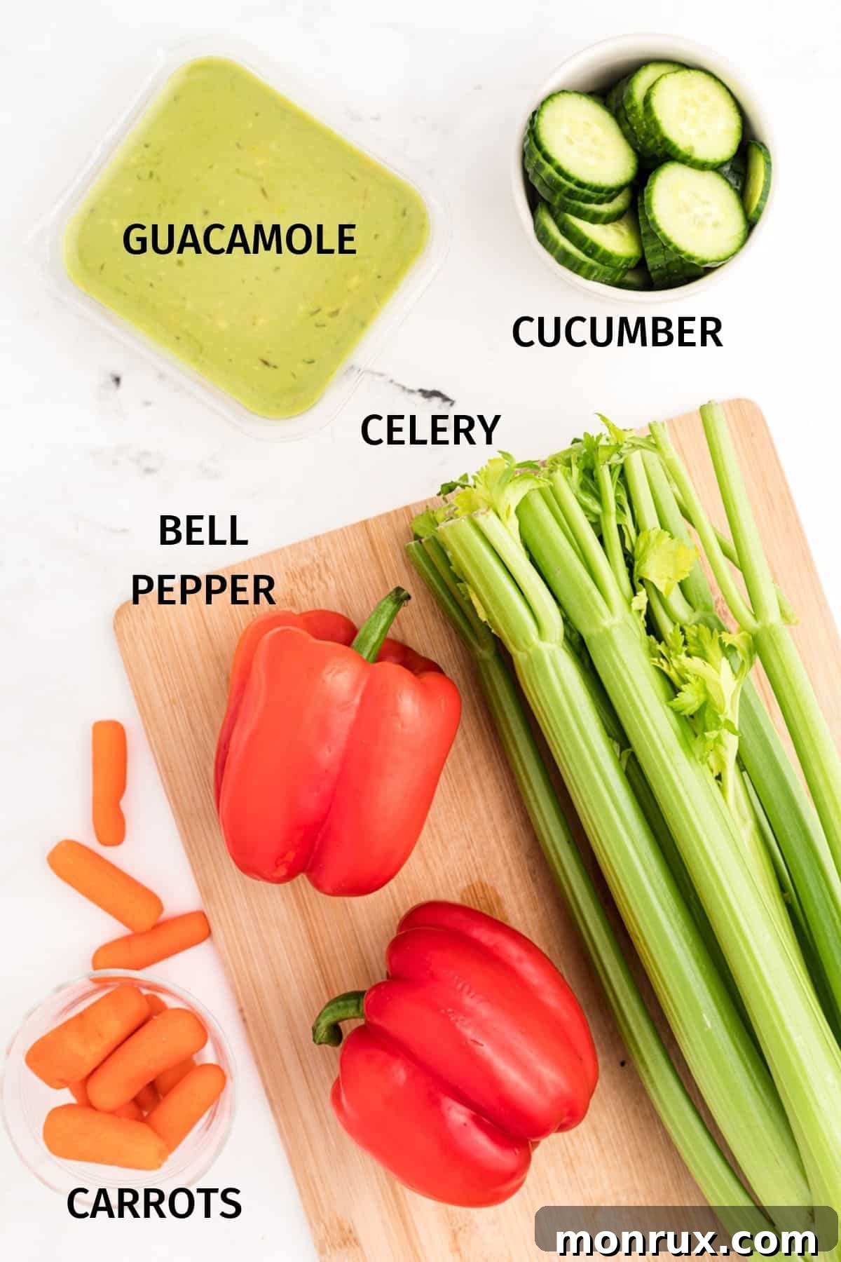 Ingredients for a turkey vegetable tray including celery, carrots, bell peppers, cucumber, and guacamole.