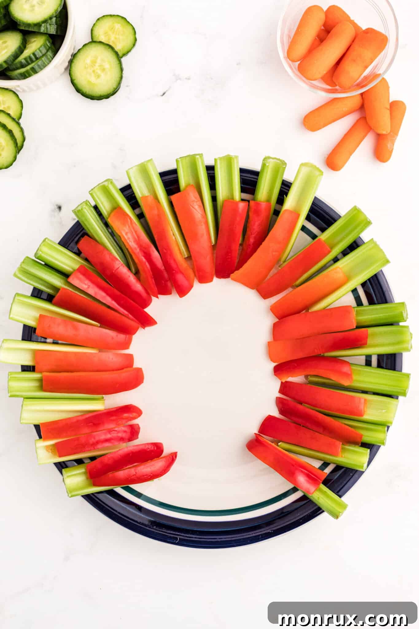 Various vegetables layered in the shape of a turkey tail on a platter.