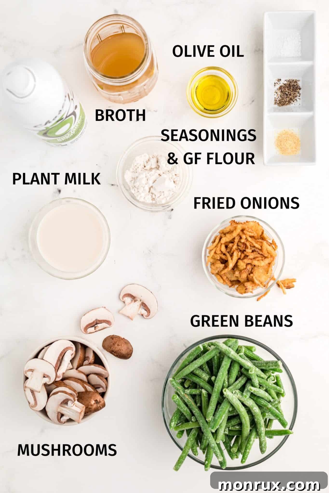 Labeled photo showcasing the key ingredients for making a dairy-free green bean casserole, including frozen green beans, mushrooms, flour, coconut milk, and broth.