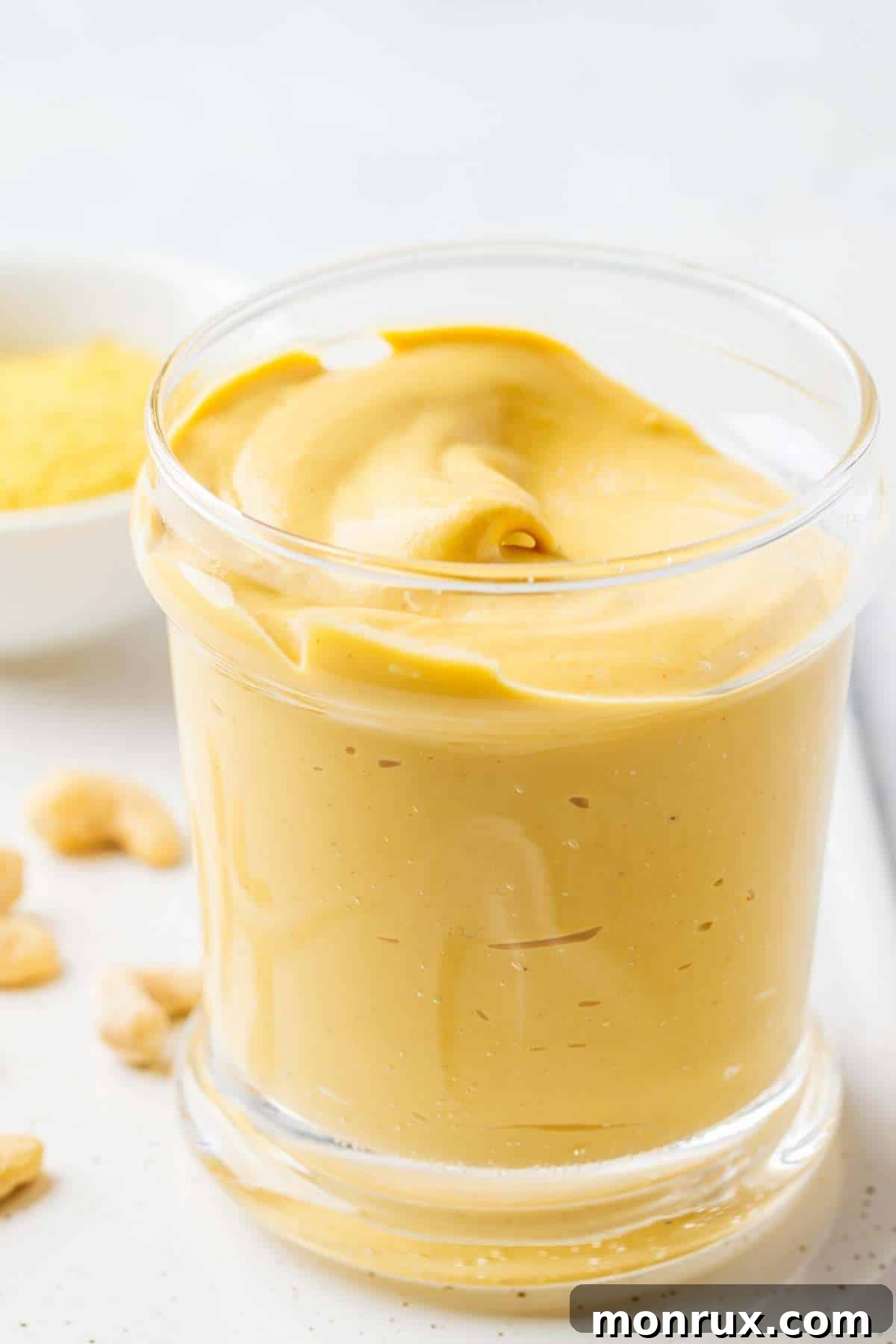 Creamy vegan cashew cheese sauce in a glass serving bowl