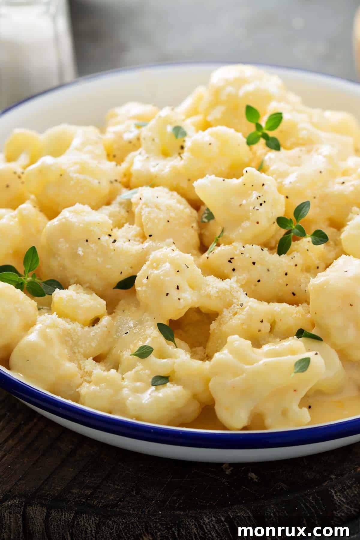 Vegan cashew cheese sauce drizzled over steamed cauliflower florets