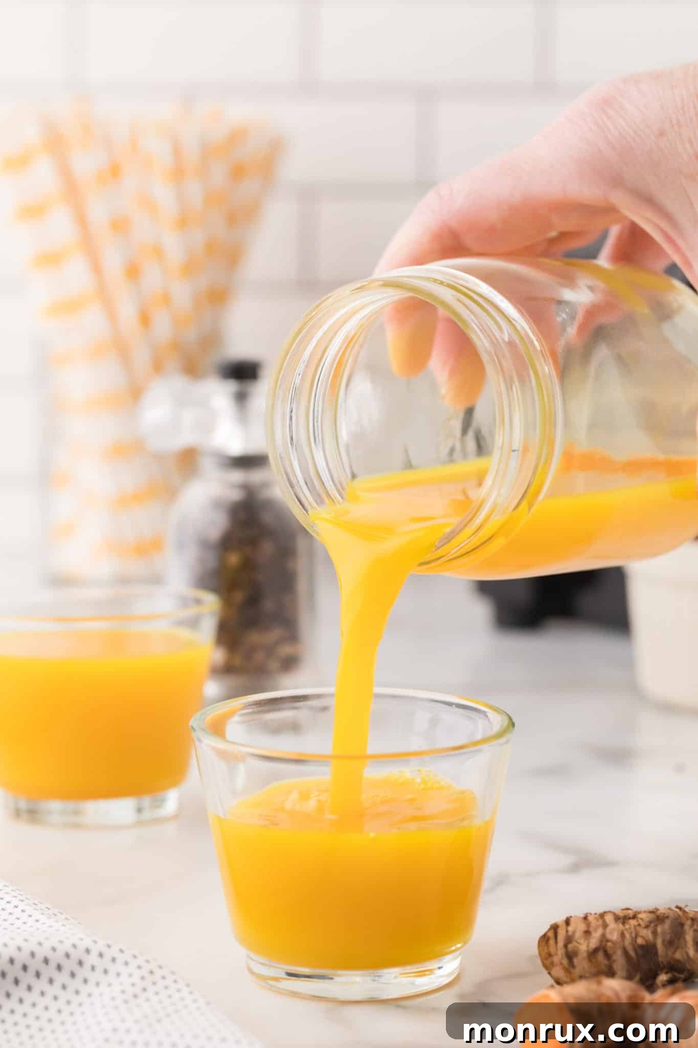 pouring a turmeric shot.