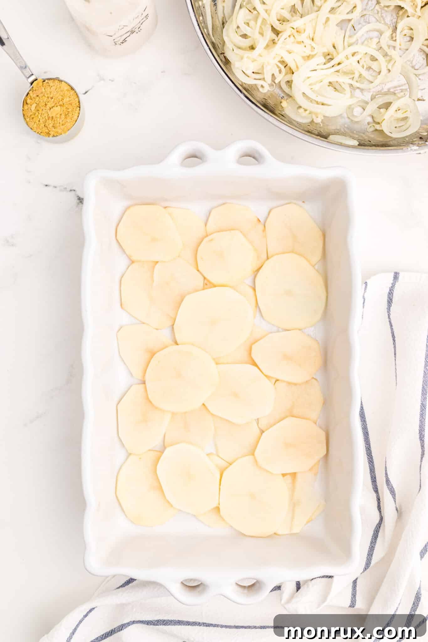 layering potatoes for scalloped potatoes recipe.