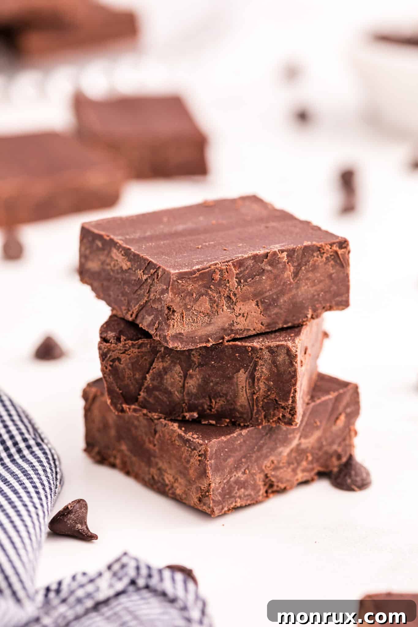 a stack of 2-ingredient fudge on a table, showcasing its rich texture.
