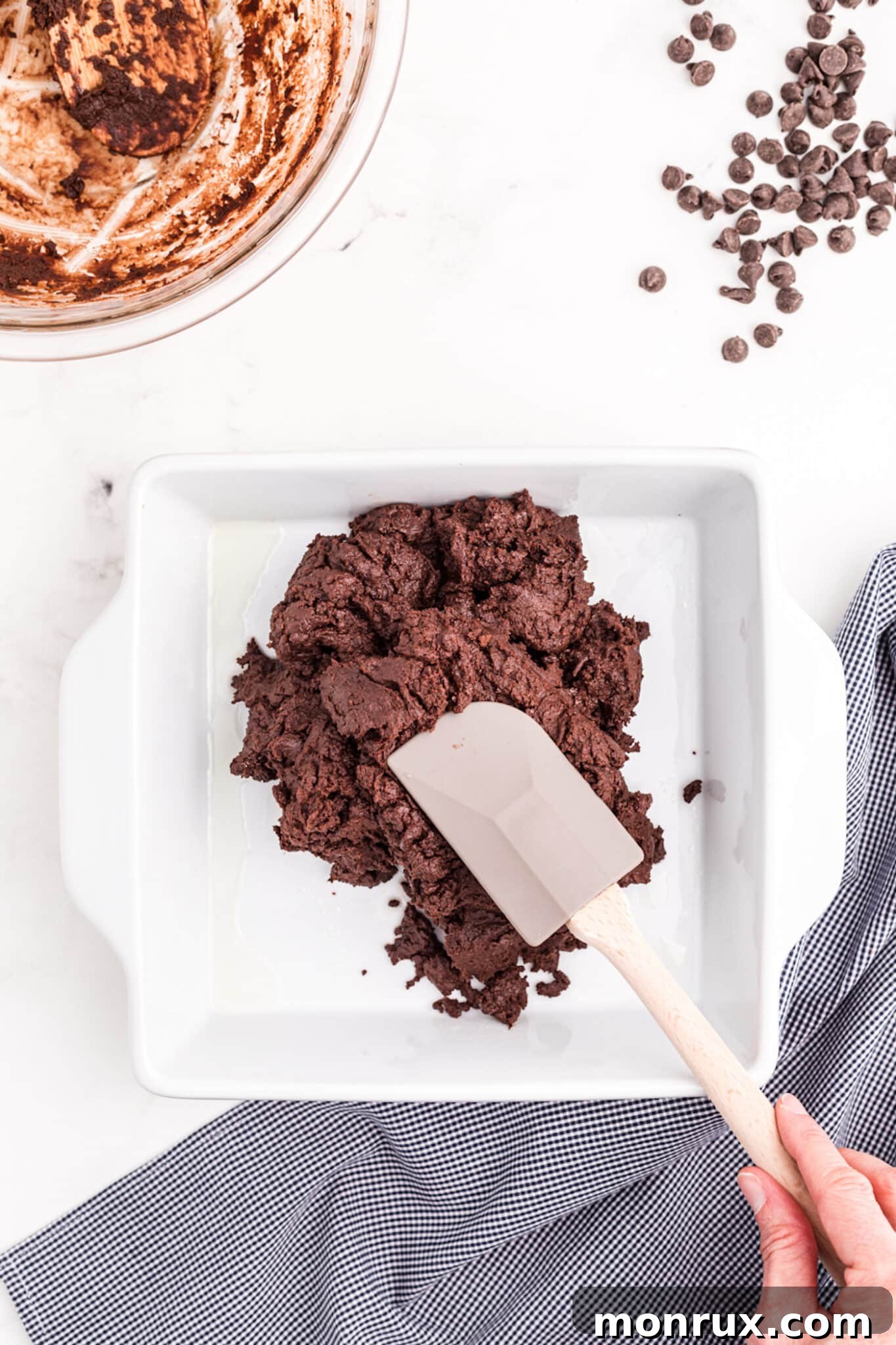 transferring smooth vegan fudge mixture to a baking dish.