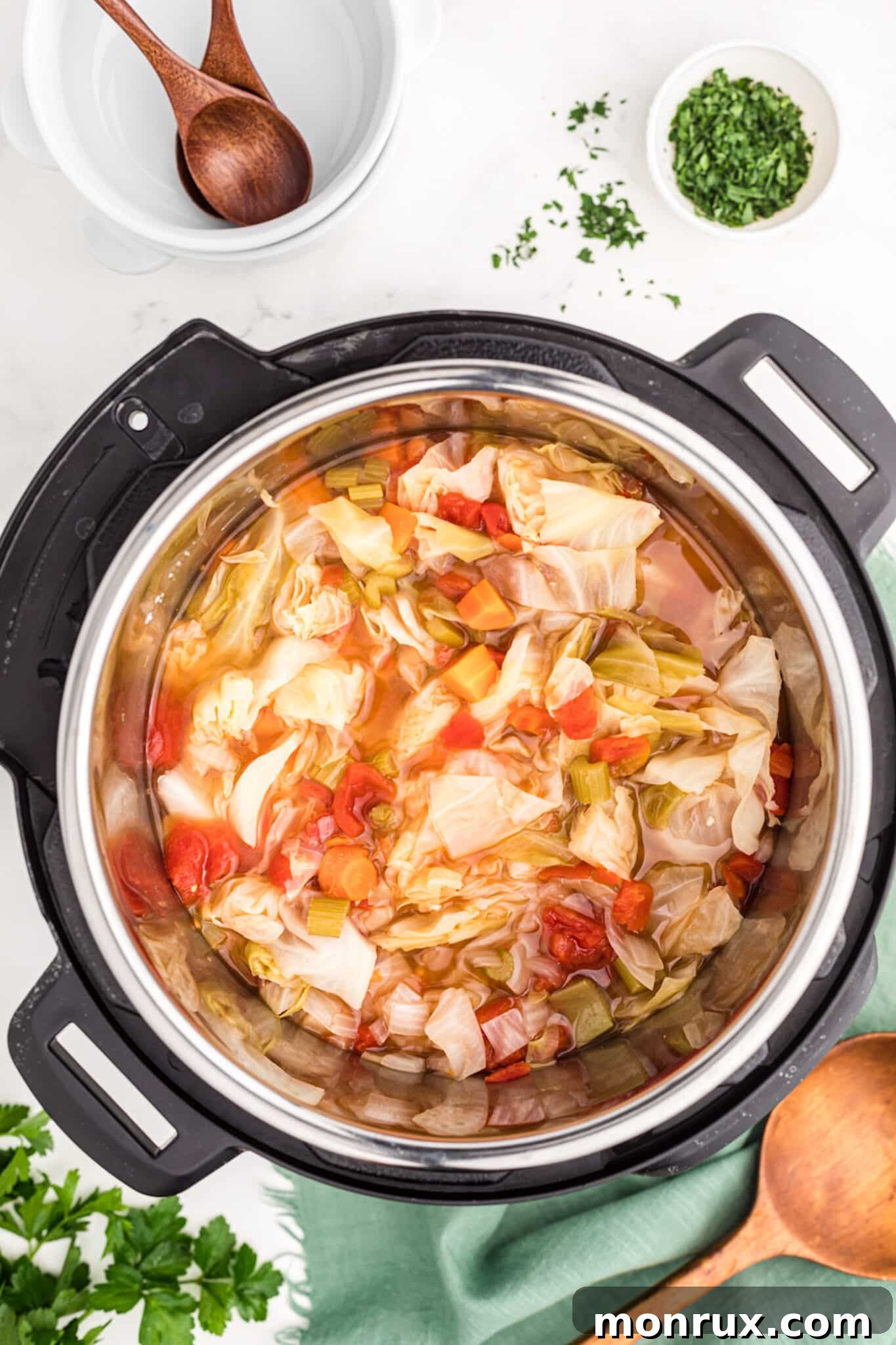 Freshly cooked vegetable cabbage soup steaming in a pressure cooker, ready for the next step.