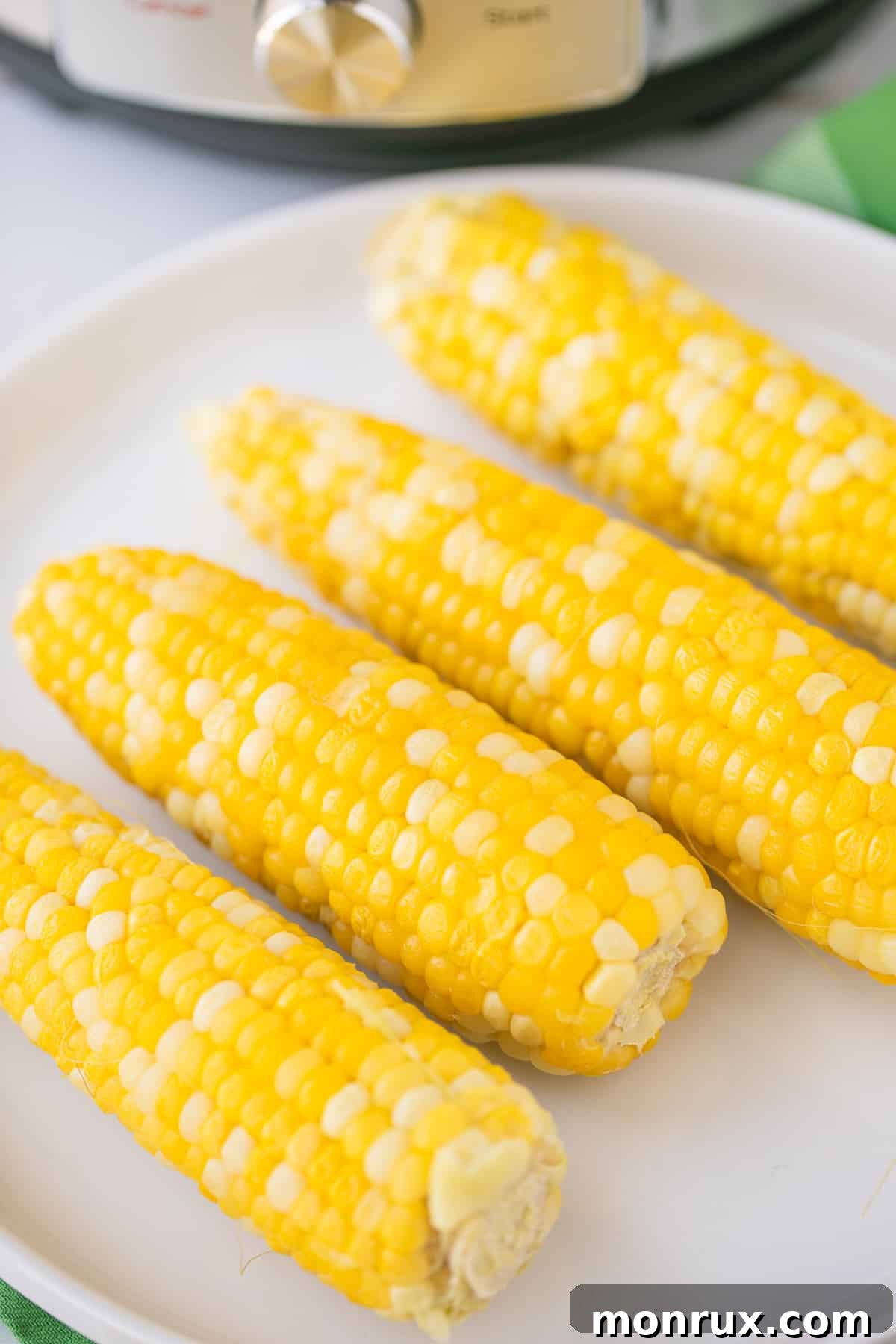 Two cobs of fresh corn, perfectly cooked in an Instant Pot, showcasing a wholesome gluten-free vegetable.