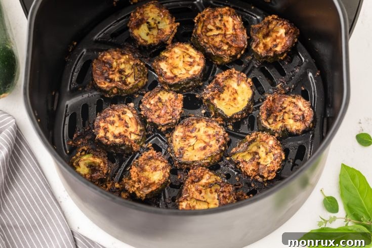 Golden brown zucchini chips with Parmesan cheese from an air fryer.