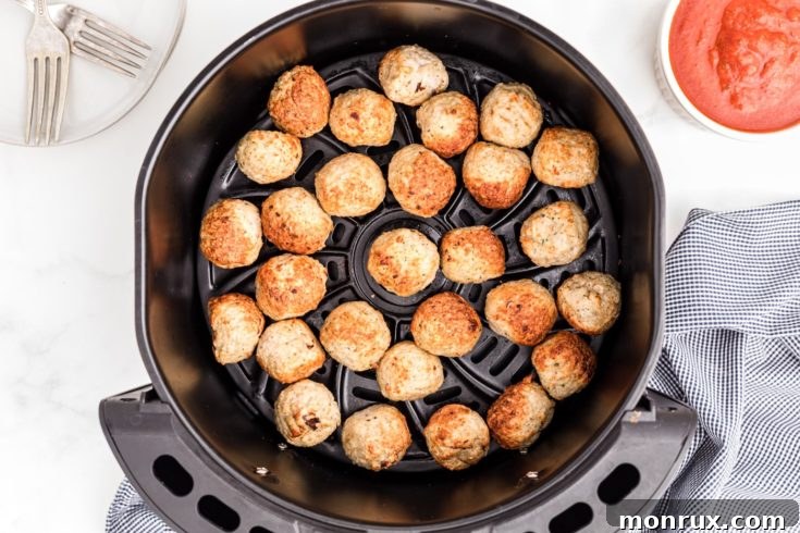 Air fried frozen meatballs in a basket.