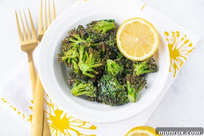 Crispy and tender air fryer broccoli with a lemon wedge.