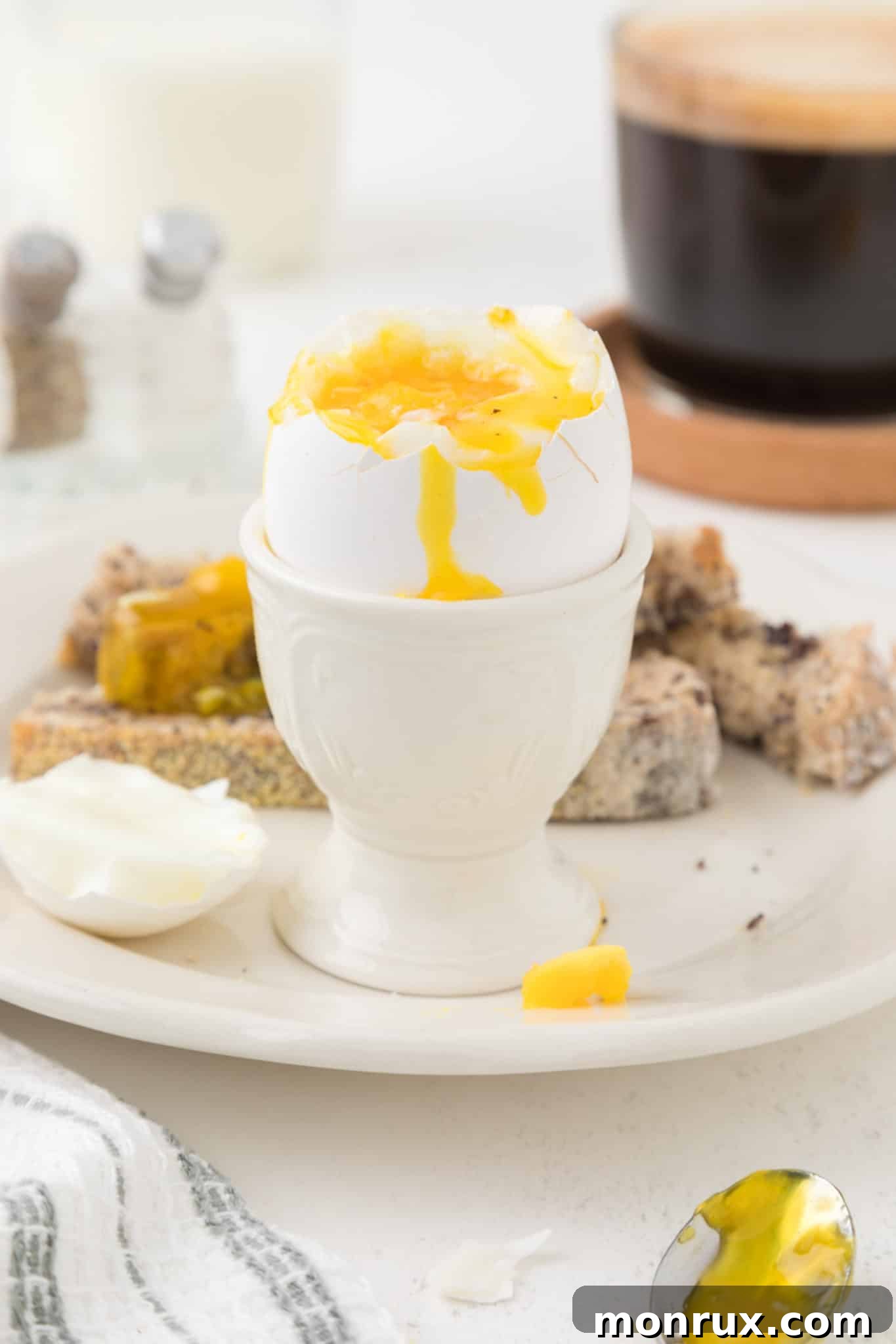Air fried soft boiled egg served in an egg cup, highlighting the creamy yolk.