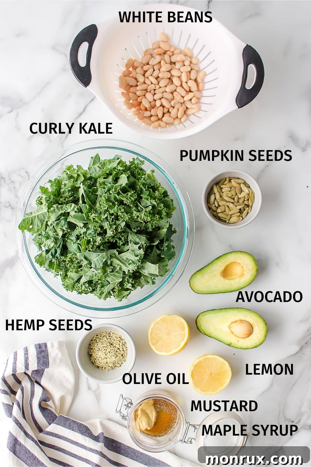 A vibrant selection of fresh ingredients laid out for the Erewhon kale salad, including kale, lemon, mustard, white beans, avocado, and seeds.