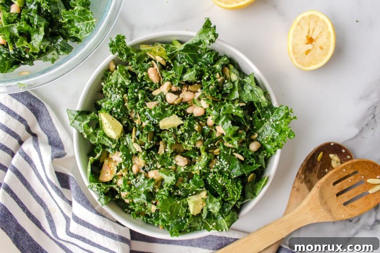 A bowl of vibrant Erewhon kale salad with avocado, white beans, and seeds, showcasing its appetizing appeal.
