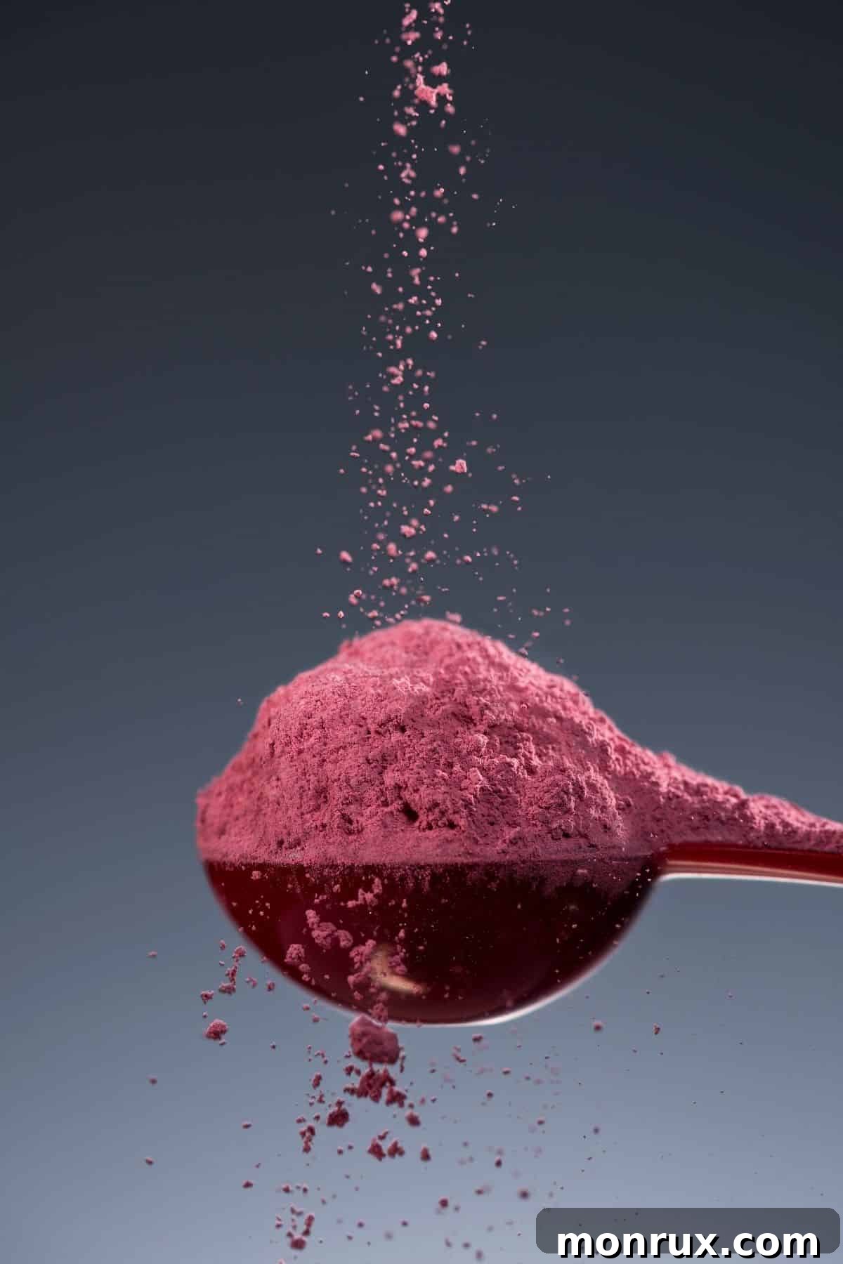 Beet powder on a spoon, illustrating its concentrated form and ease of use.