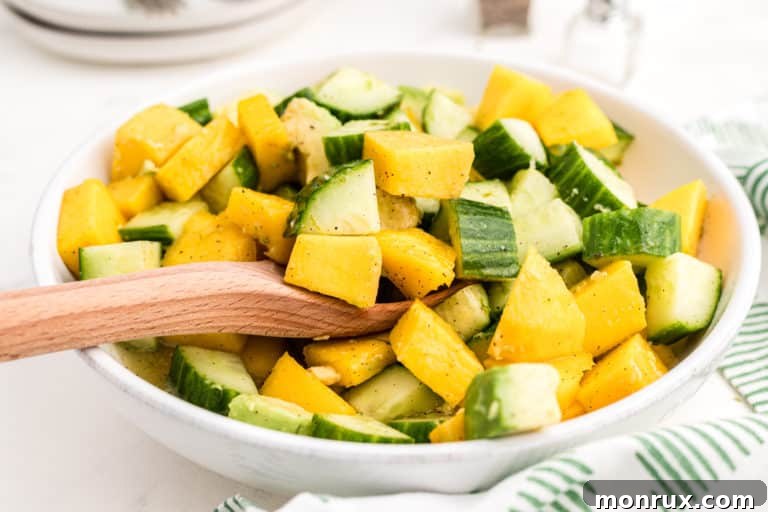A vibrant and refreshing bowl of Cucumber Mango Avocado Salad, ready to be enjoyed.