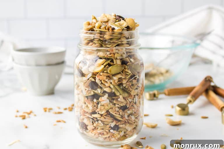 A jar of sugar free trail mix, with a focus on the texture and variety of ingredients.