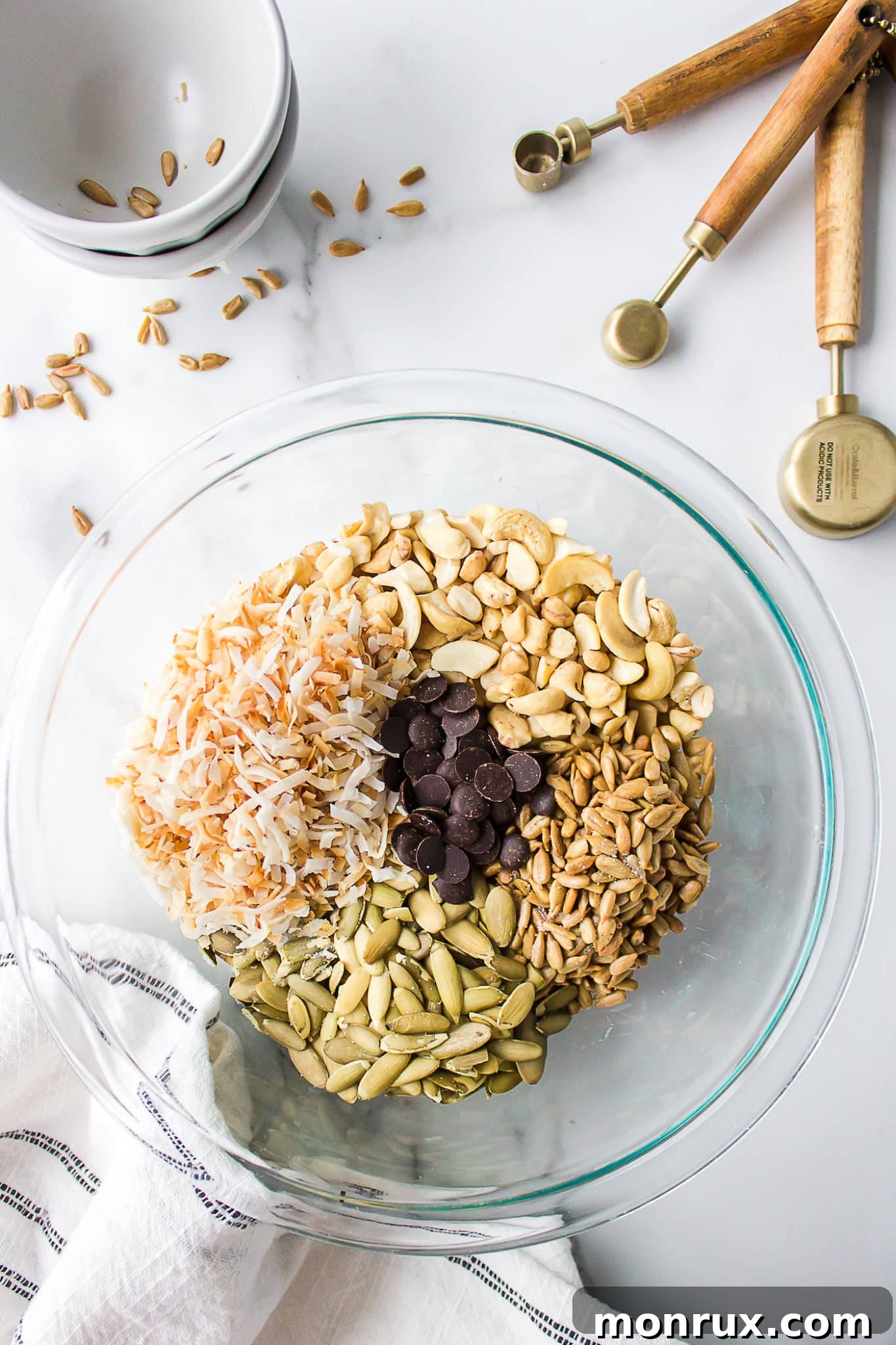 A mixing bowl filled with the colorful ingredients for homemade trail mix, ready to be combined.