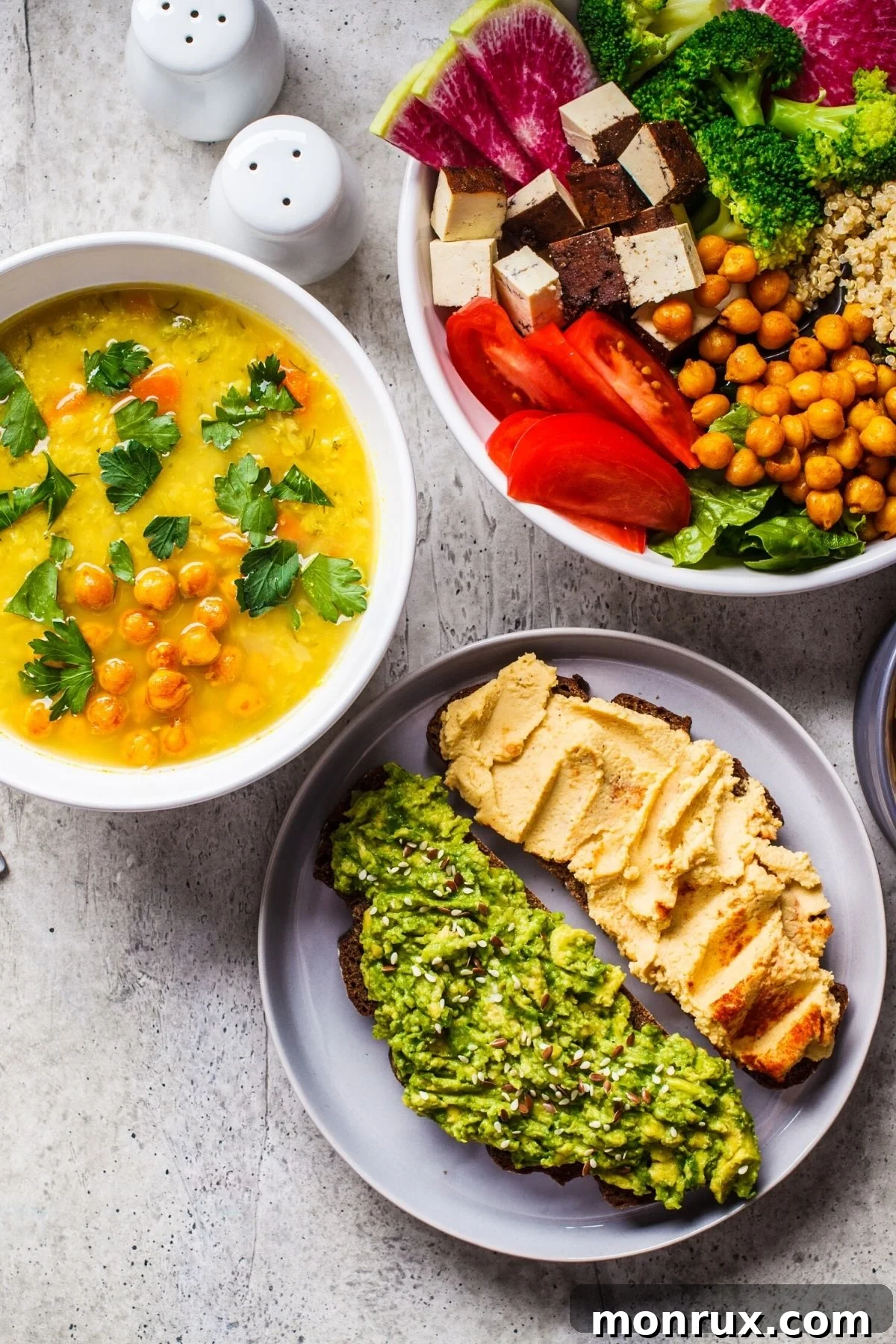 A table brimming with an assortment of colorful, beautifully plated plant-based meals, showcasing the diversity and appeal of vegan gluten-free cuisine.