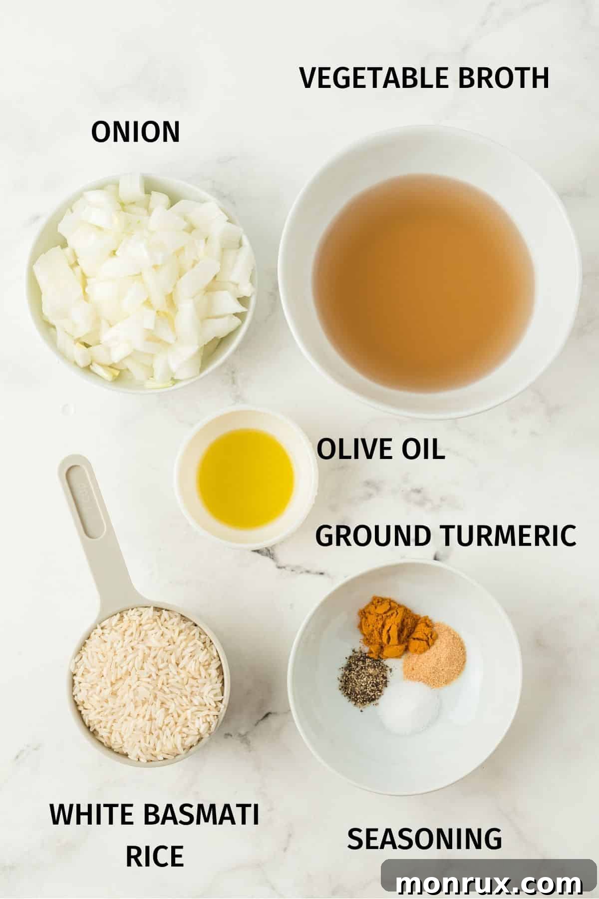A flat lay image showing the key ingredients for Instant Pot yellow rice: white basmati rice, ground turmeric, garlic powder, salt, pepper, diced onion, olive oil, and vegetable broth.